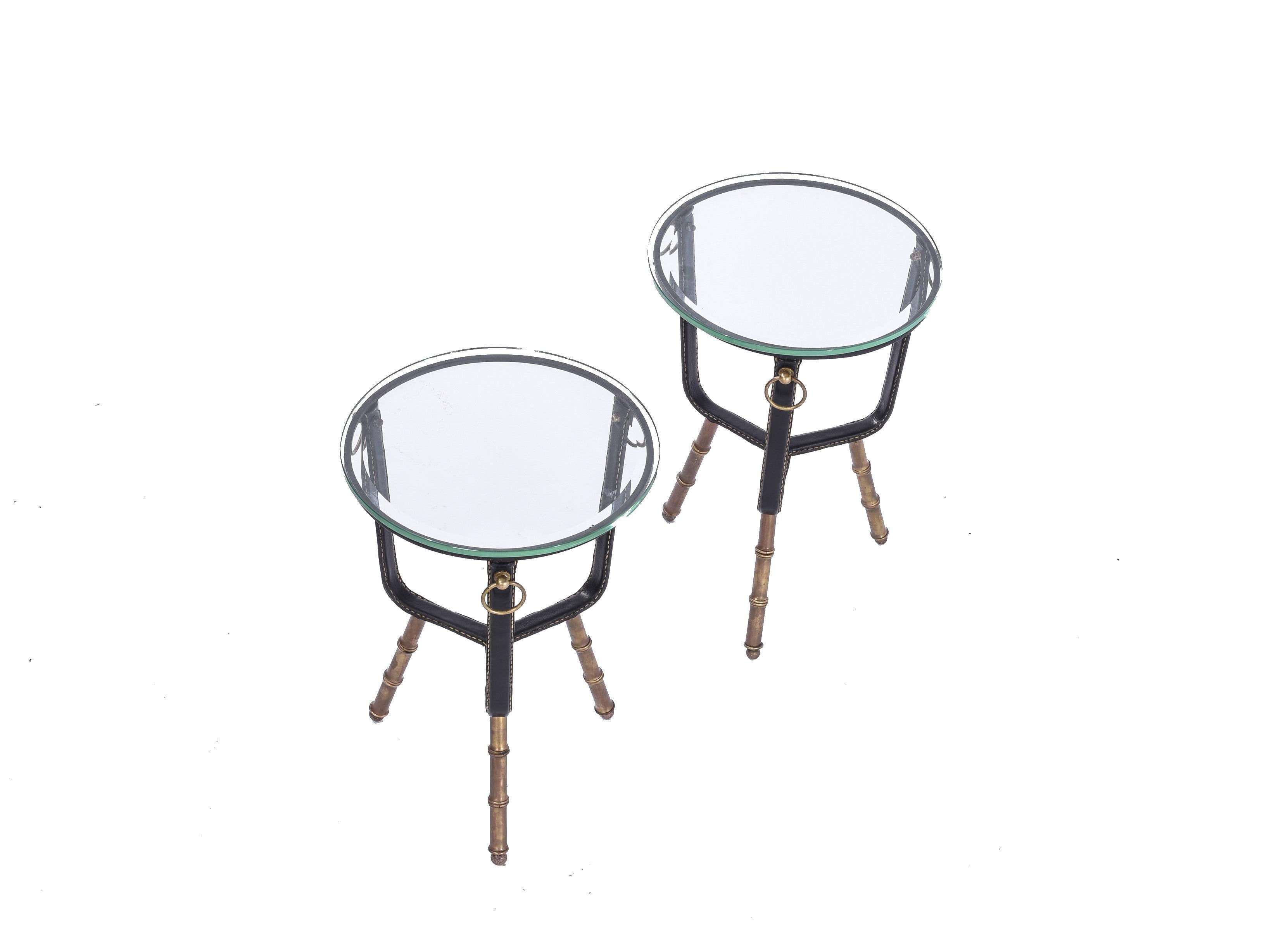Jacques Adnet pair of side tables, France, 1960s. Stitched leather, enameled iron, brass, glass.