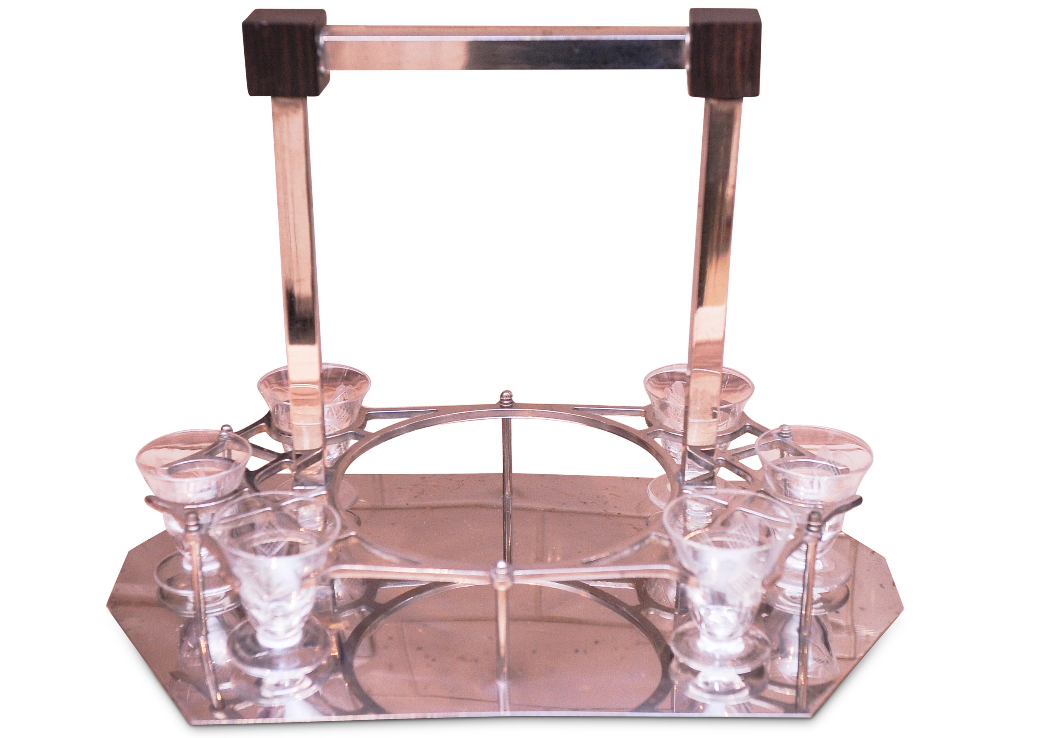 Manner of Jacques Adnet. Stylish Art Deco Liqueur Set With Chromed Octagonal Base & Rosewood Block Cornices Features A Central Glass Decanter and Six Etched Glasses 1920's 


