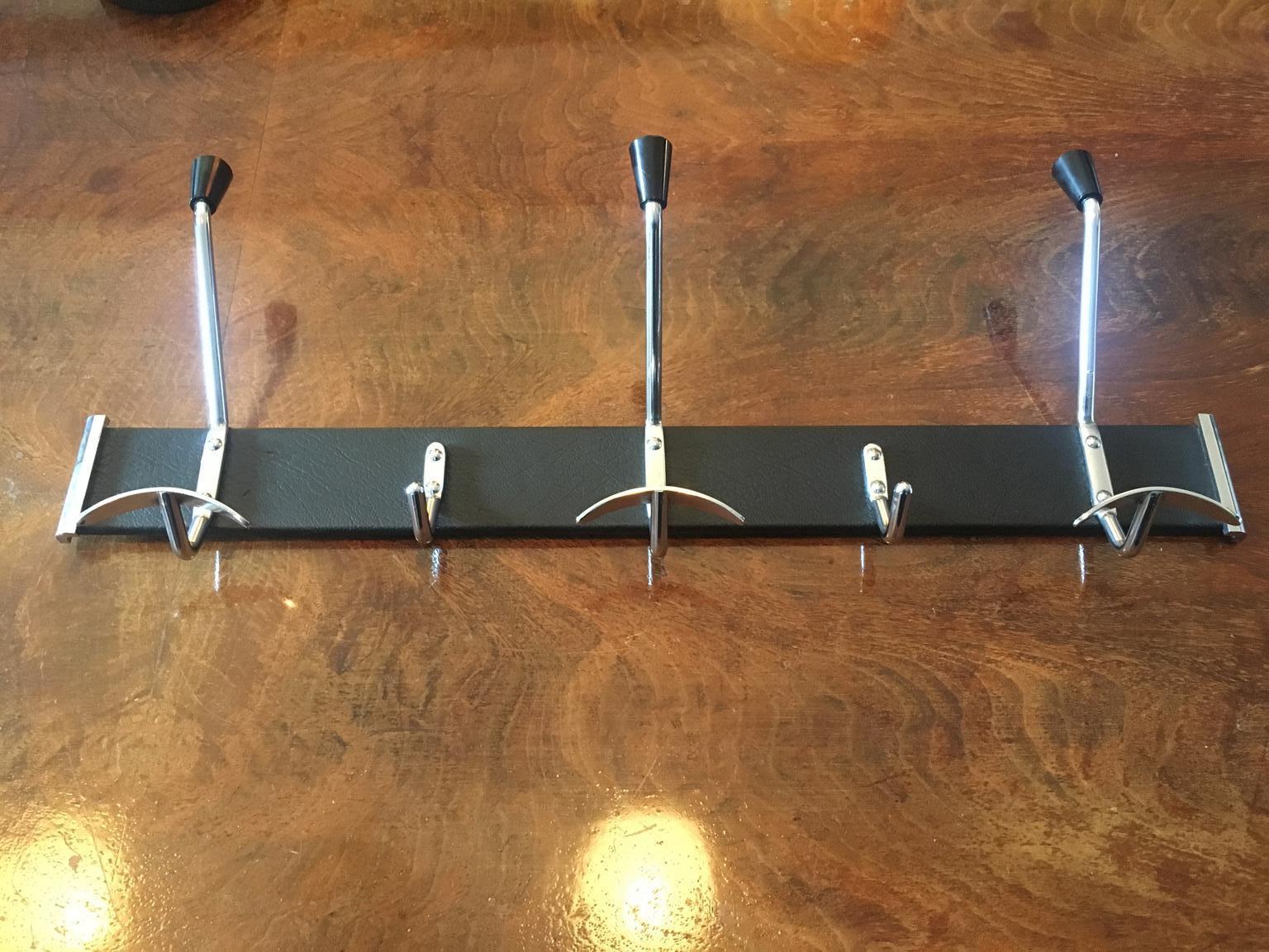 Jacques Adnet style black leather hanger, coat rack, 
Mid-Century Modern, France, 1950s.
In a very good general condition.
 


 