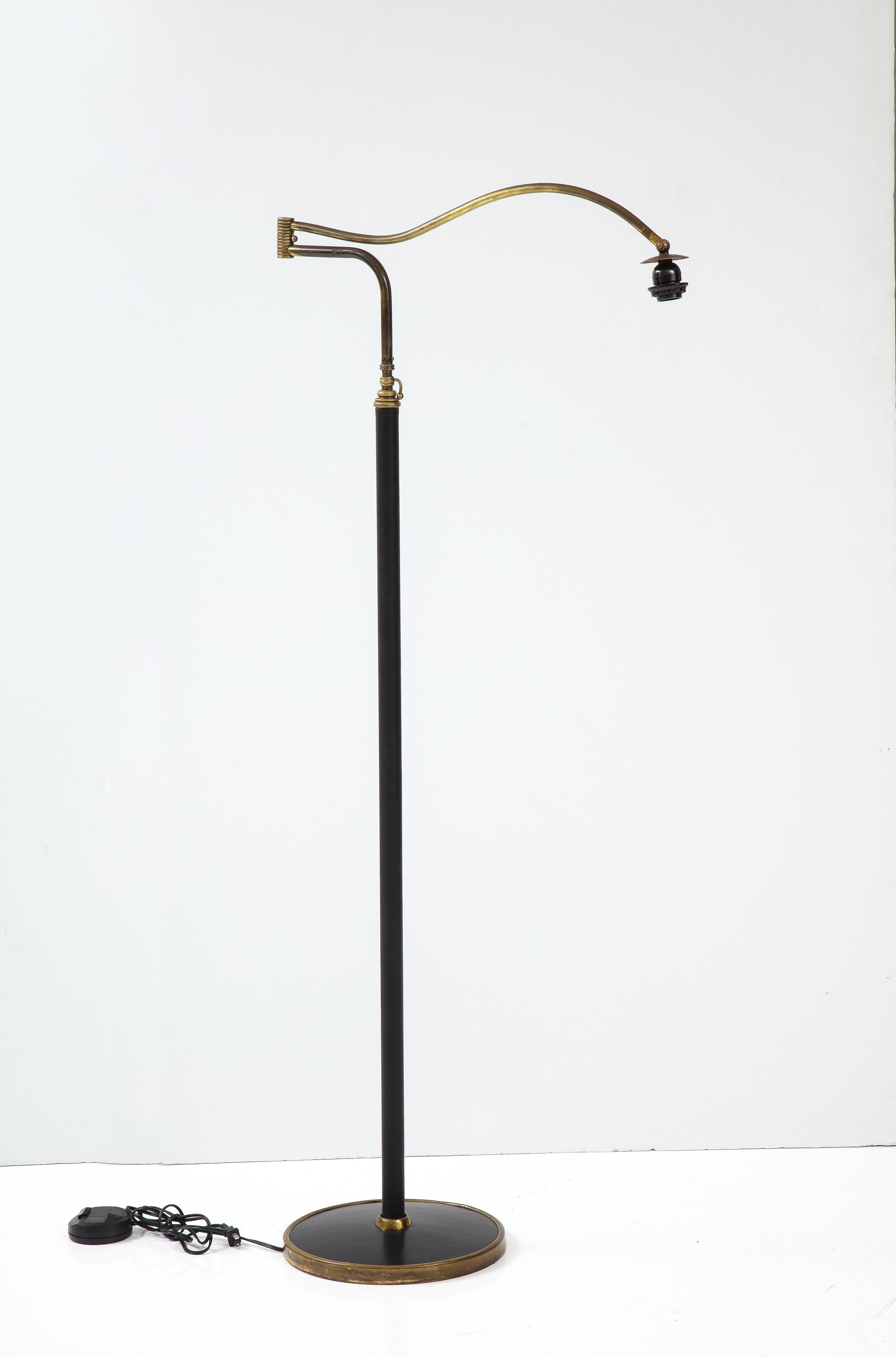 Stunning 1940's French Jacques Adnet style brass and leather adjustable floor, in vintage original condition with some wear and beautiful patina to the brass and minor wear to the leather.