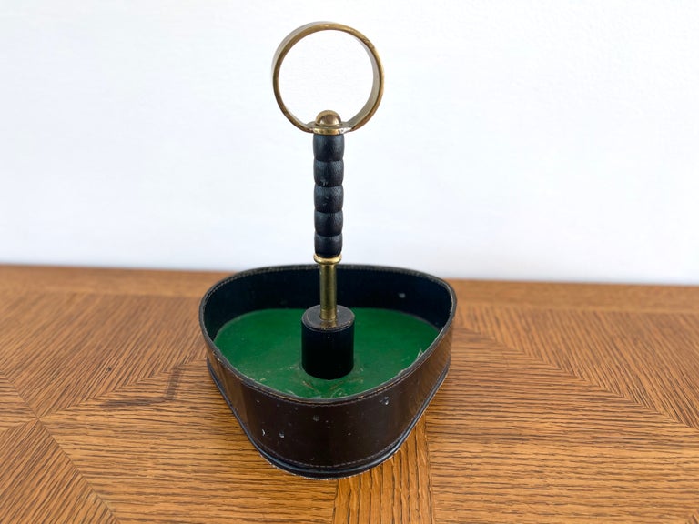Handsome catchall attributed to Jacques Adnet with brass loop handle, leather curved sides and green felt interior.