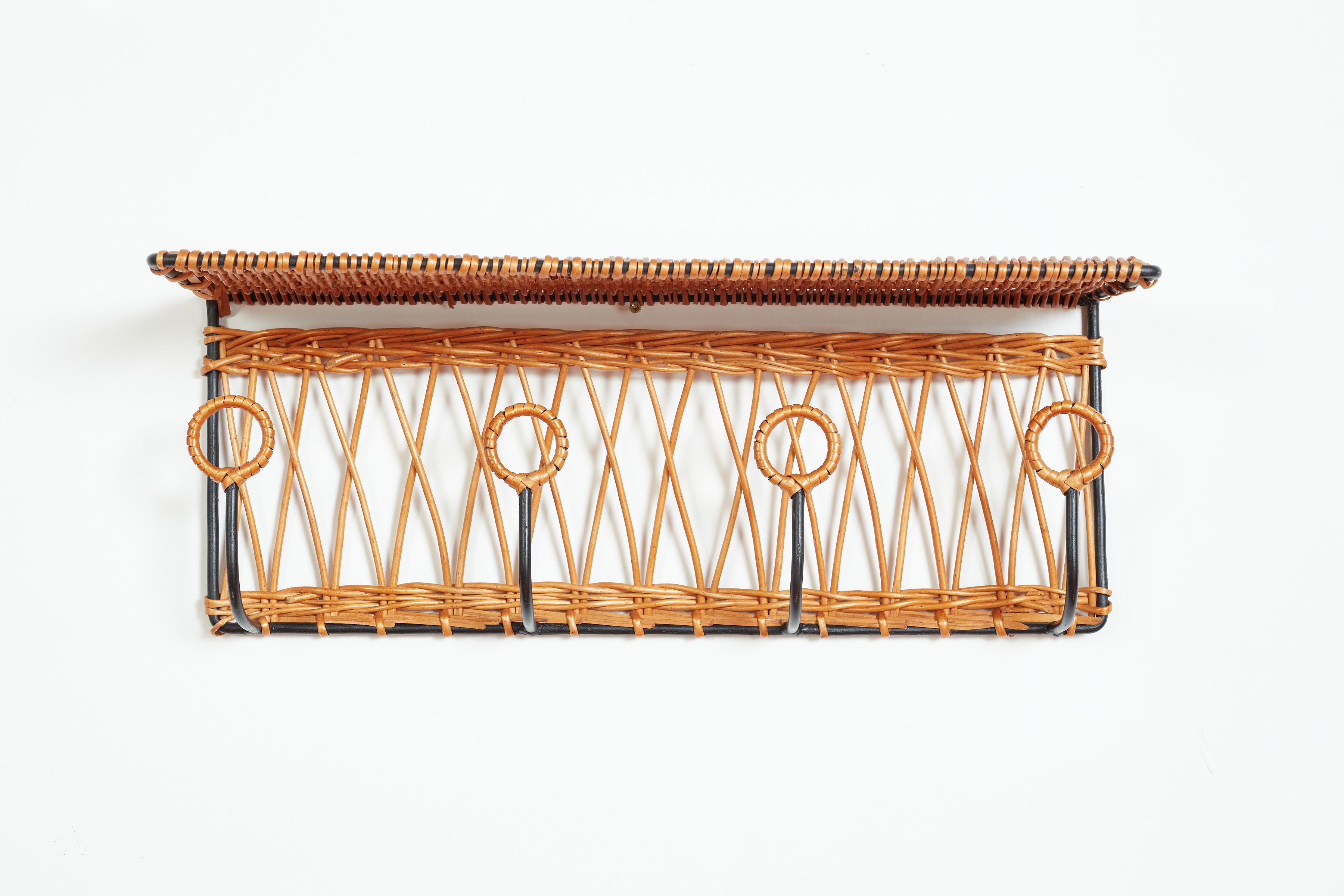 French coat rack attributed to Jacques Adnet made of iron and willow. Beautiful woven detail with 4 iron wrapped hooks and top shelf.