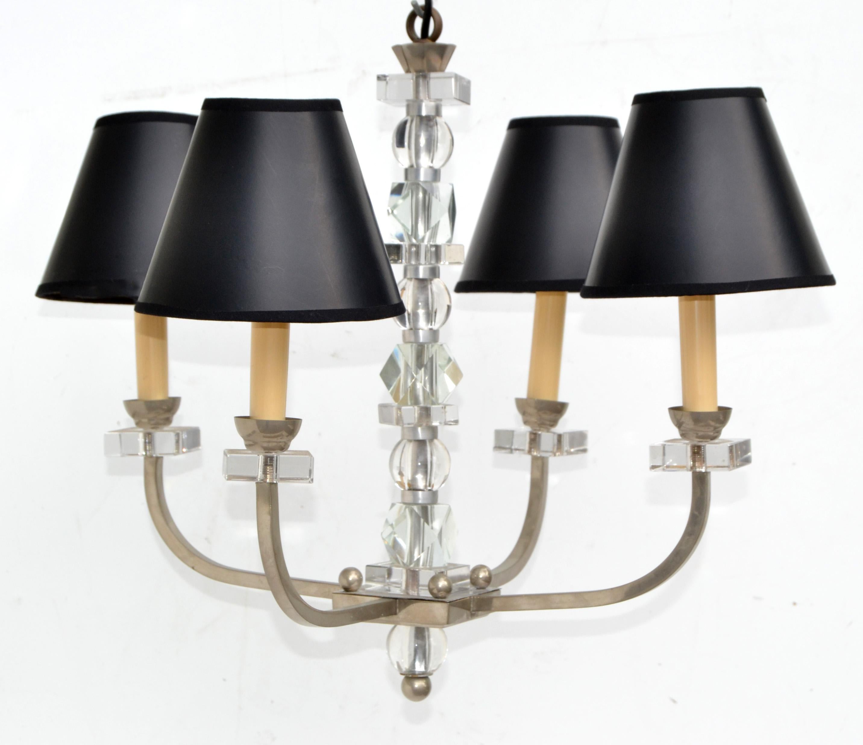 Four lights nickel-plated over brass chandelier in the style of Jacques Adnet.
Stem and sockets are decorated with geometric shaped faceted Glass pieces.
Come with the black & gold clip on paper shades.
US rewired and in working condition, takes
