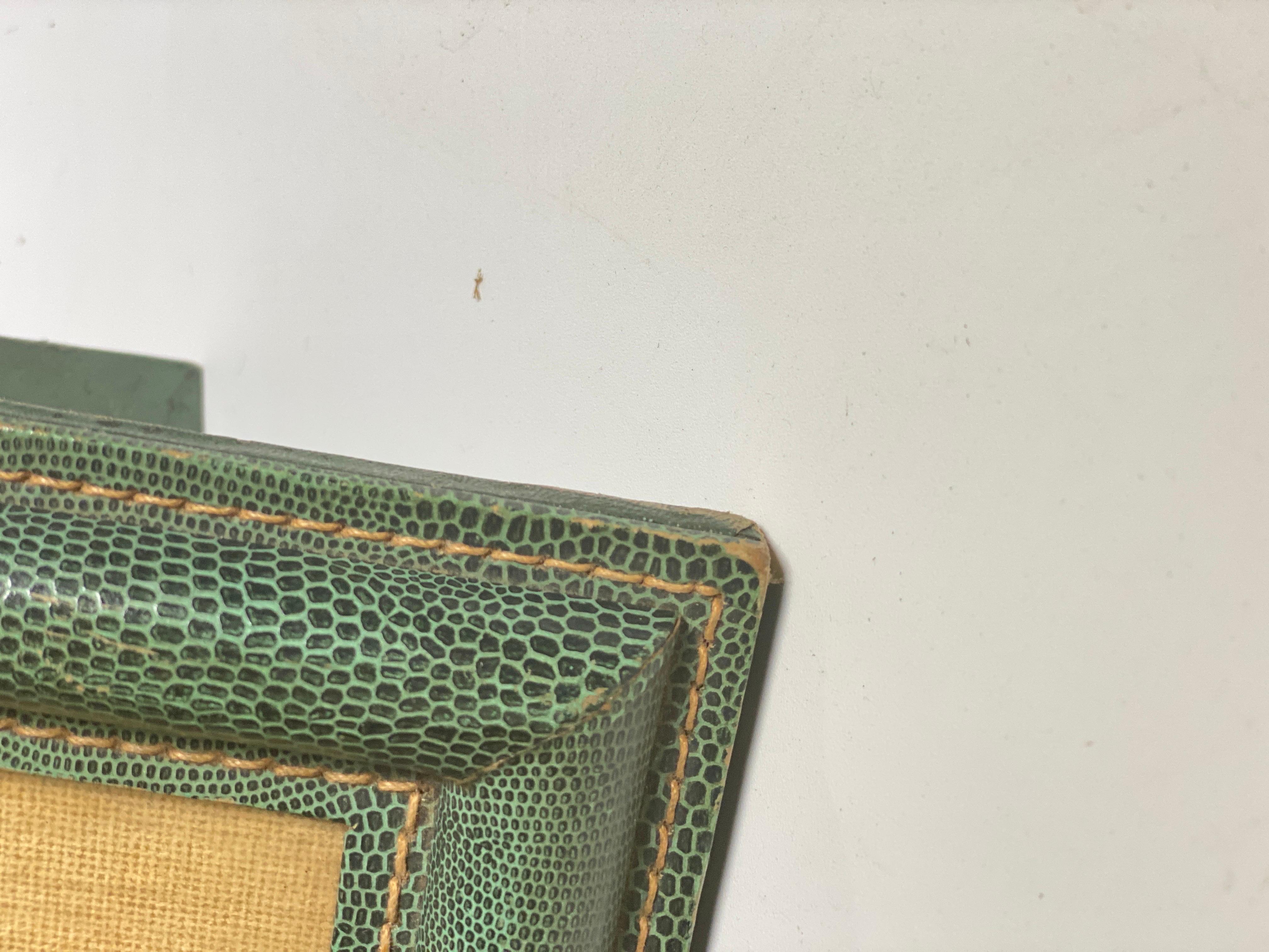 This Picture frame, is in stitched leather, in a light green color. It is done in the style of Jacques Adnet. Some Wear but almost on the sides. It has been made in France circa 1940, it is the Art Deco Period.