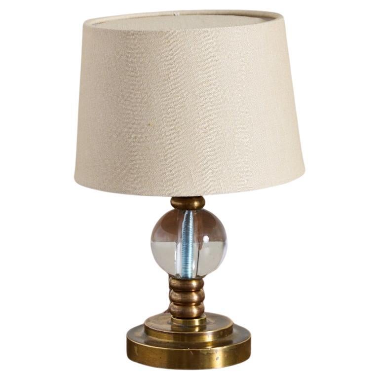 Petite Jacques Adnet style brass table lamp with glass sphere and ornate brass detail. 

Rewired with new silk shade.
 