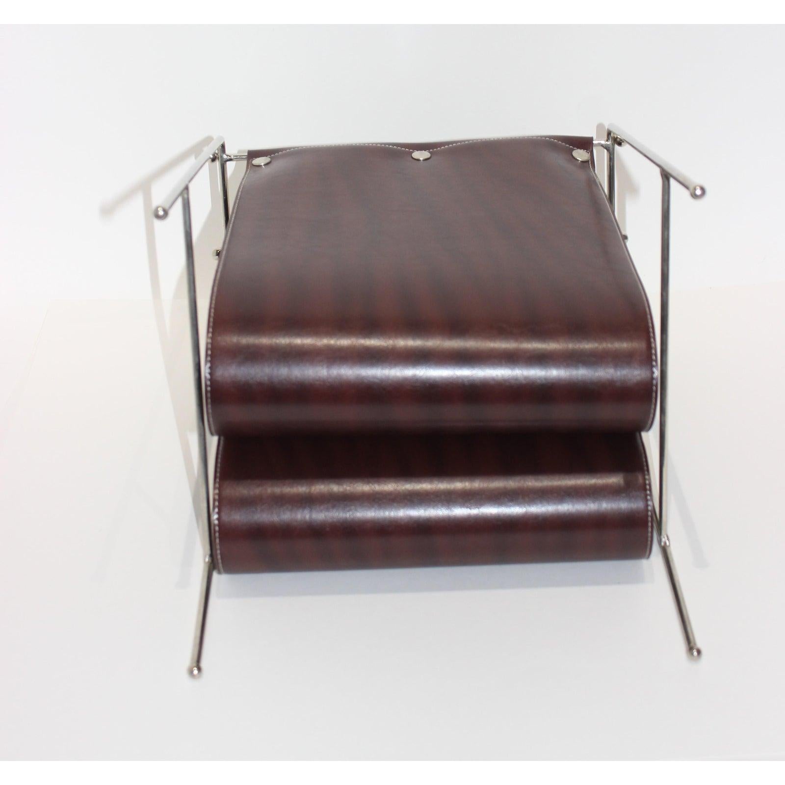 This stylish magazine holder is very much in the form of pieces created by Jacques Adnet and will hold all your favorite read's. The piece is fabricated in polished chrome and a brown colored vinyl (faux leather) fabric.