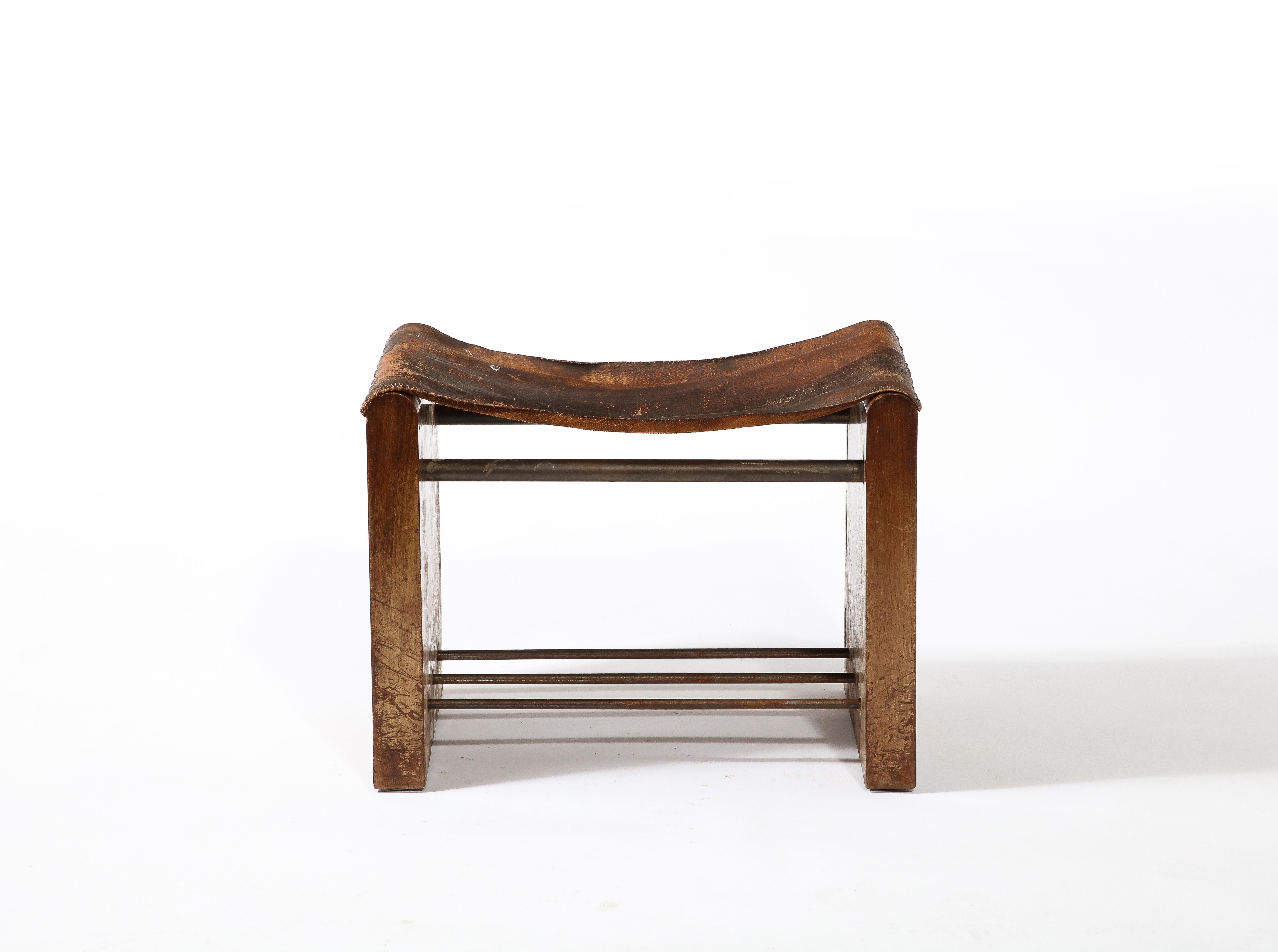 Handsome modernist stool or small bench form attributed to Adnet. Incredible patina. Restoration to leather is required. 