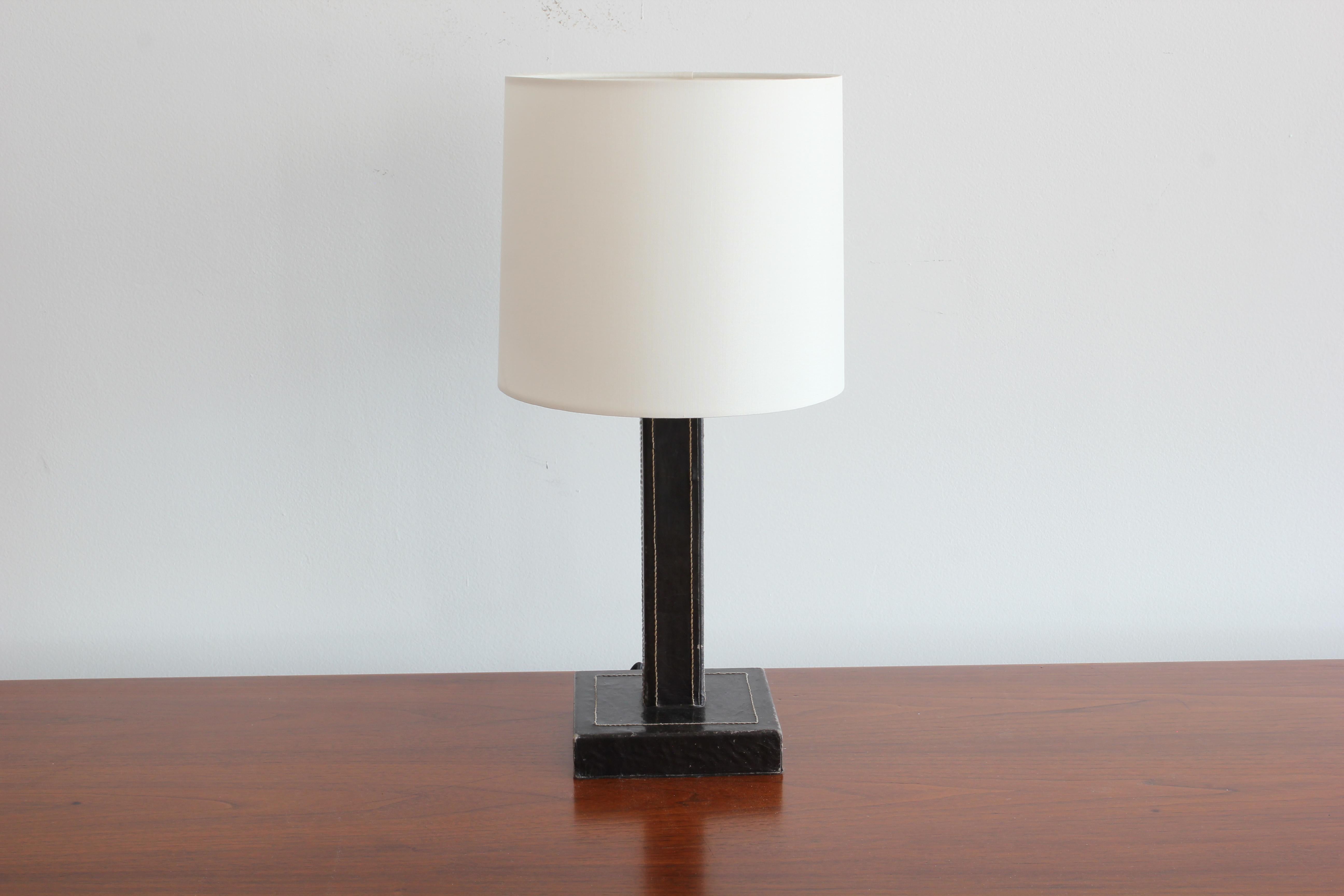 Jacques Adnet style table lamp
Black leather with contrast stitching
New shade and newly rewired.