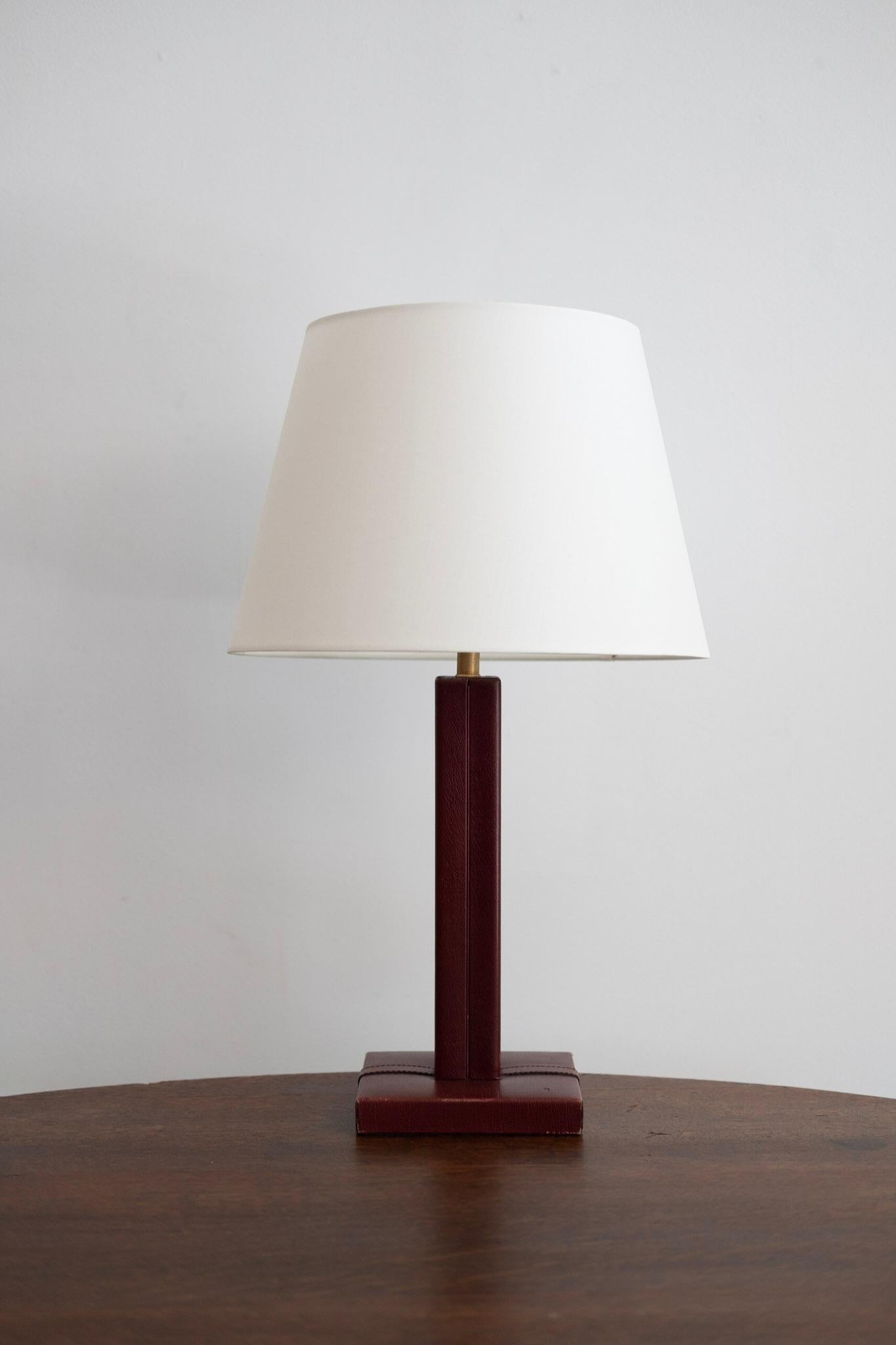 Jacques Adnet style table lamp with dark brown leather with contrast stitching, 
new shade and newly rewired.