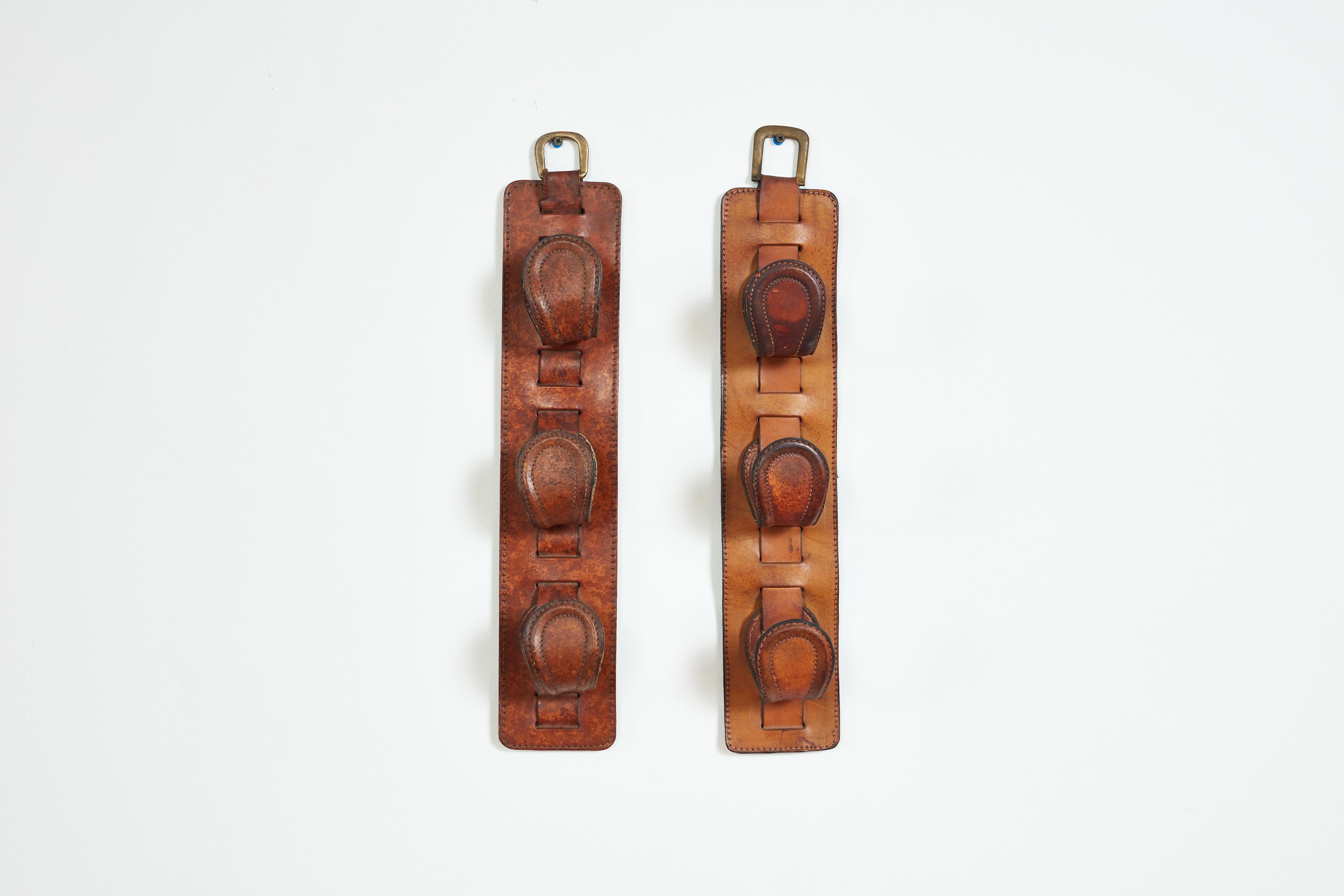 Handsome boathooks in the style of Jacques Adnet
Tongue shaped vertical set of 3 wall hanging hooks
Brass hardware -
Wonderful patina
Priced individually-slightly different in style.