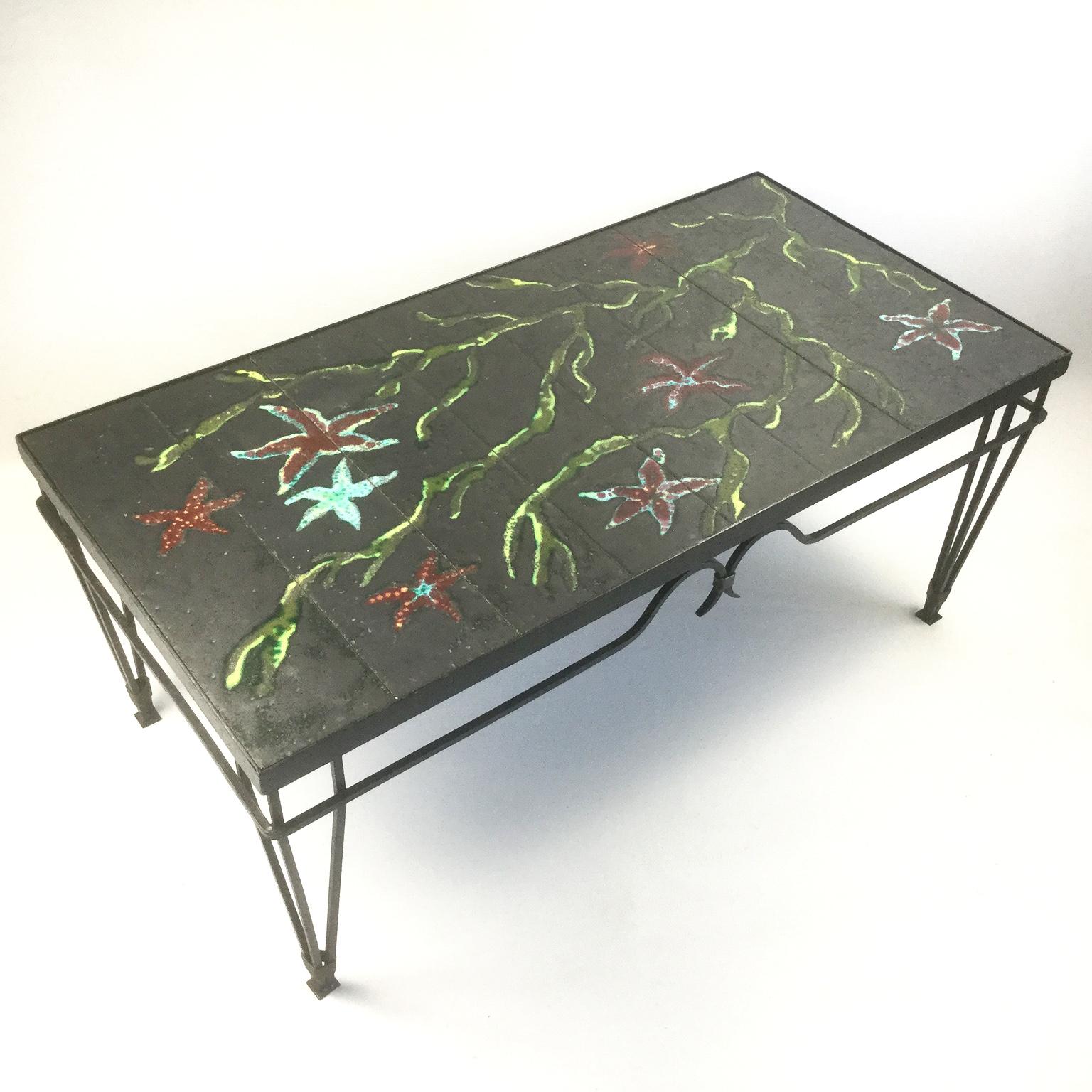 The 1940s wrought iron and lava enamel coffee table attributed to Jacques Adnet and Colette Gueden
Neoclassical wrought iron base with 8 enamel plaques created a marine decoration.