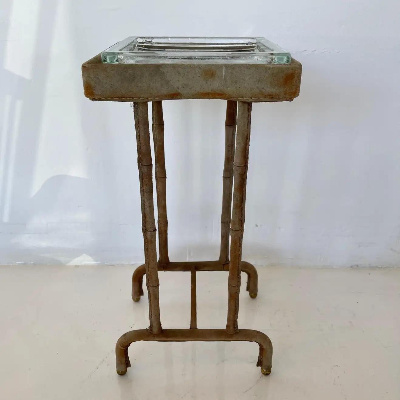 Stunning suede side table / catchall by French designer Jacques Adnet. Completely wrapped suede frame with glass catchall on top. Signature Adnet contrast stitching. Brass ball feet. Great vintage condition. Super functional. Excellent piece of