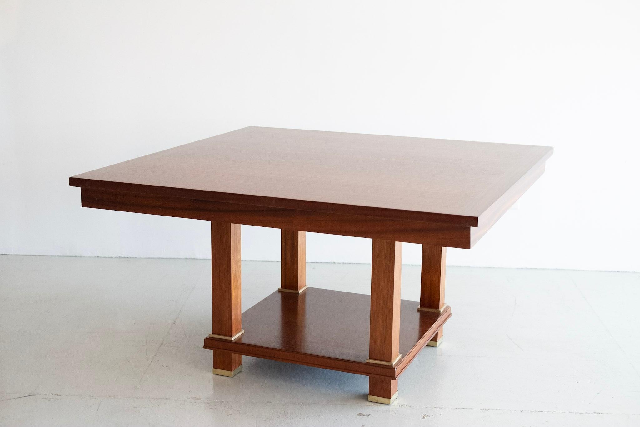 Important Jacques Adnet library table with thick square mahogany top with over flowing edge connected to four straight legs with bronze feet.
Collaboration with designer Andre Arbus for the Palais des Consuls de Rouen, 1955.
  