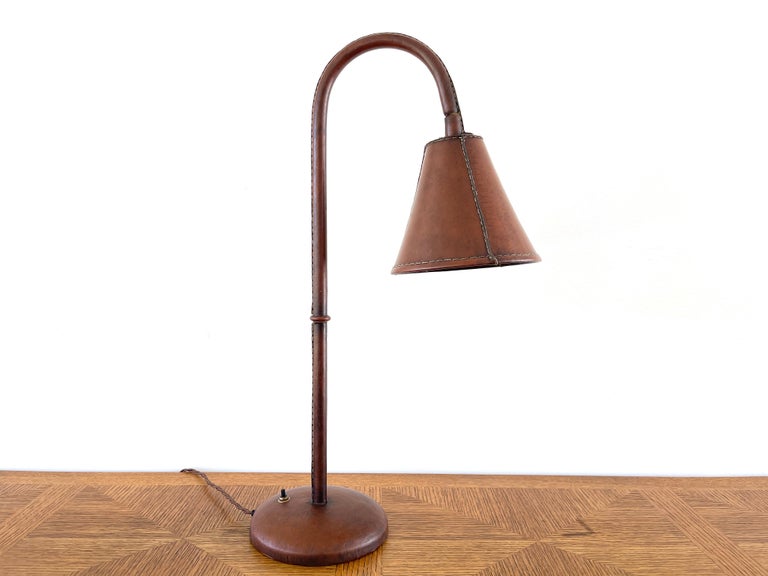 Jacques Adnet leather lamp with contrast stitching and wonderful patina.