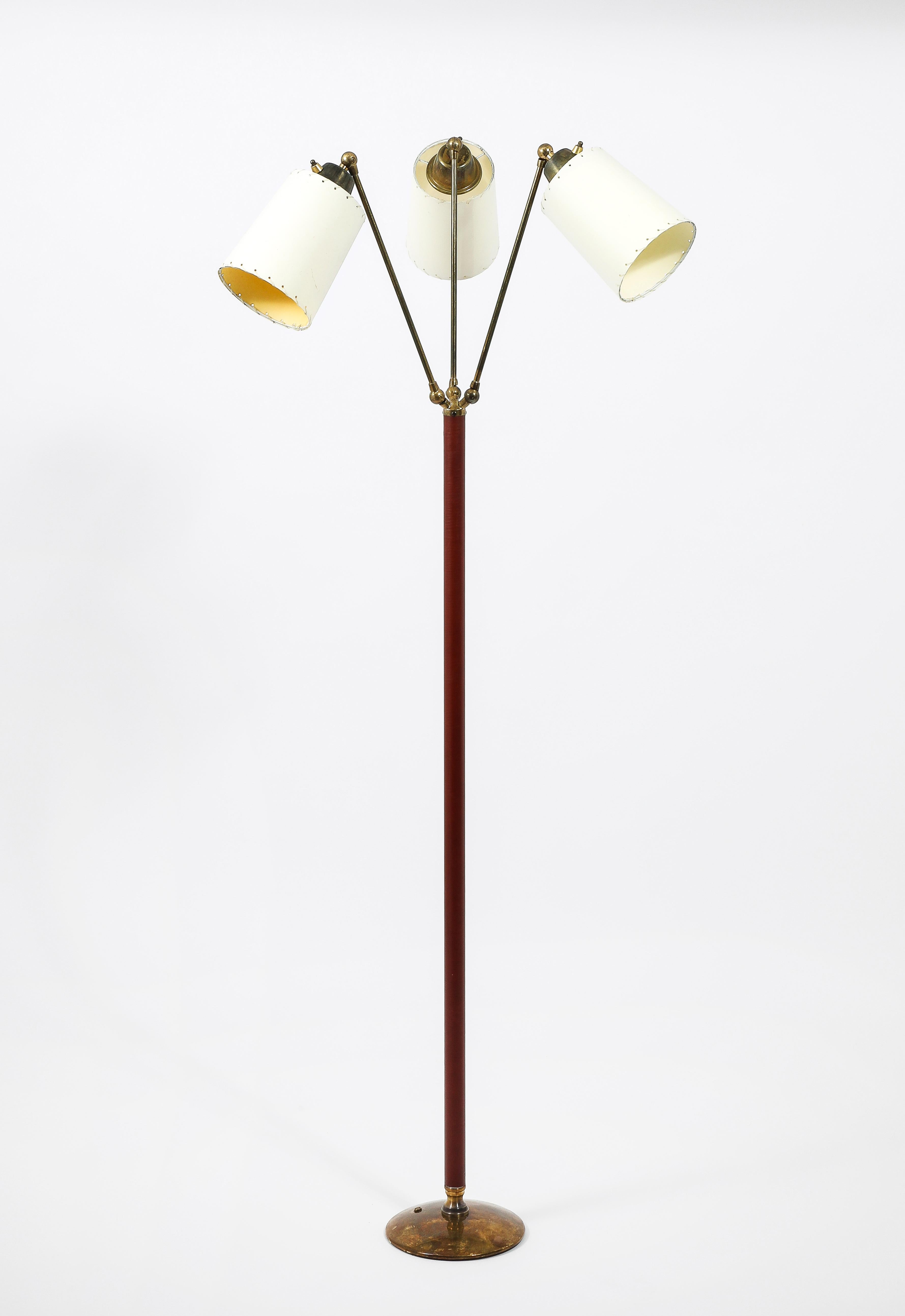 Fully adjustable floor lamp with three independent brass arms, leather stitched stem on a brass base. Wired with shades.