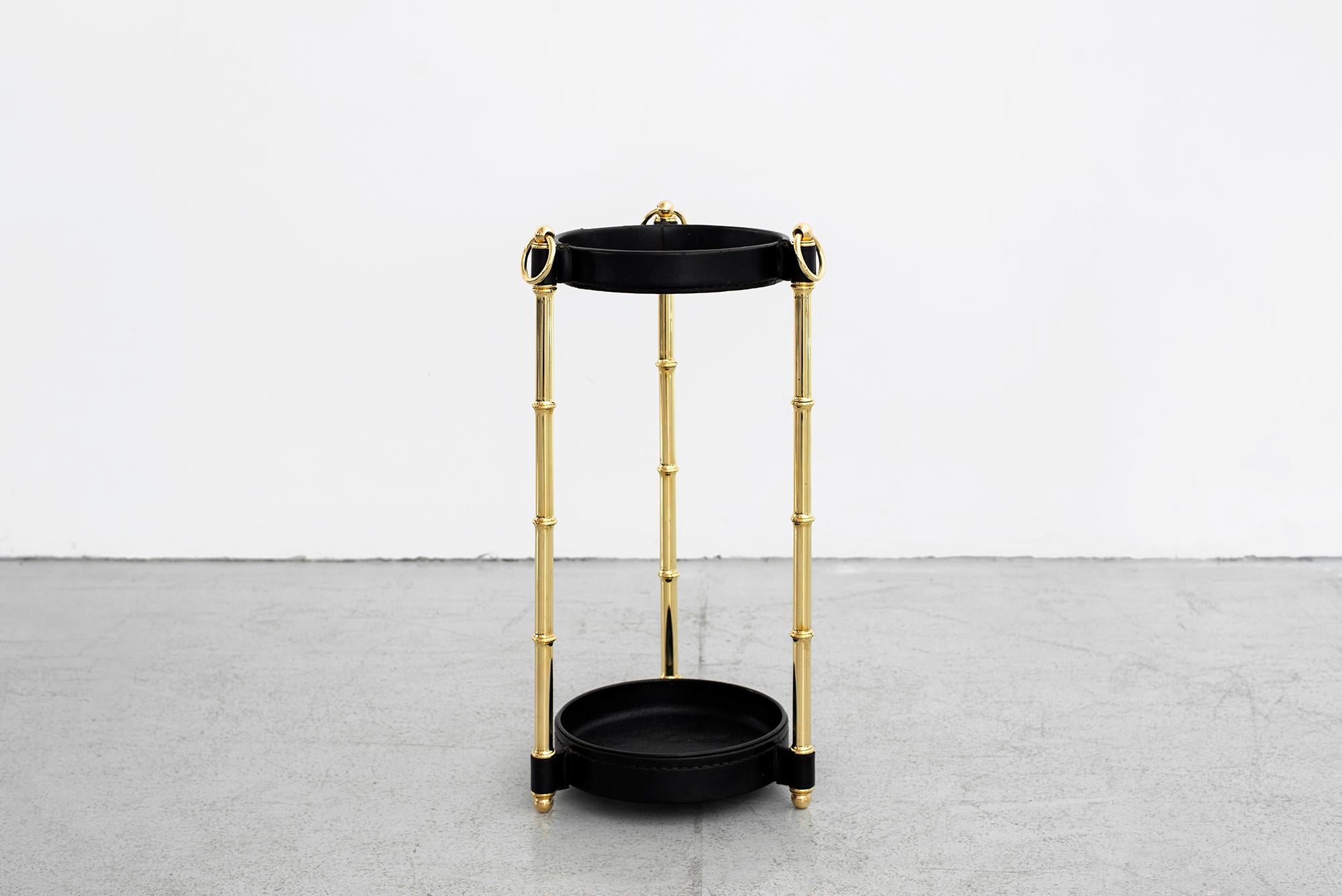 Handsome leather and brass bamboo umbrella stand by Jacques Adnet.
Brass and black leather with signature contrast stitching.