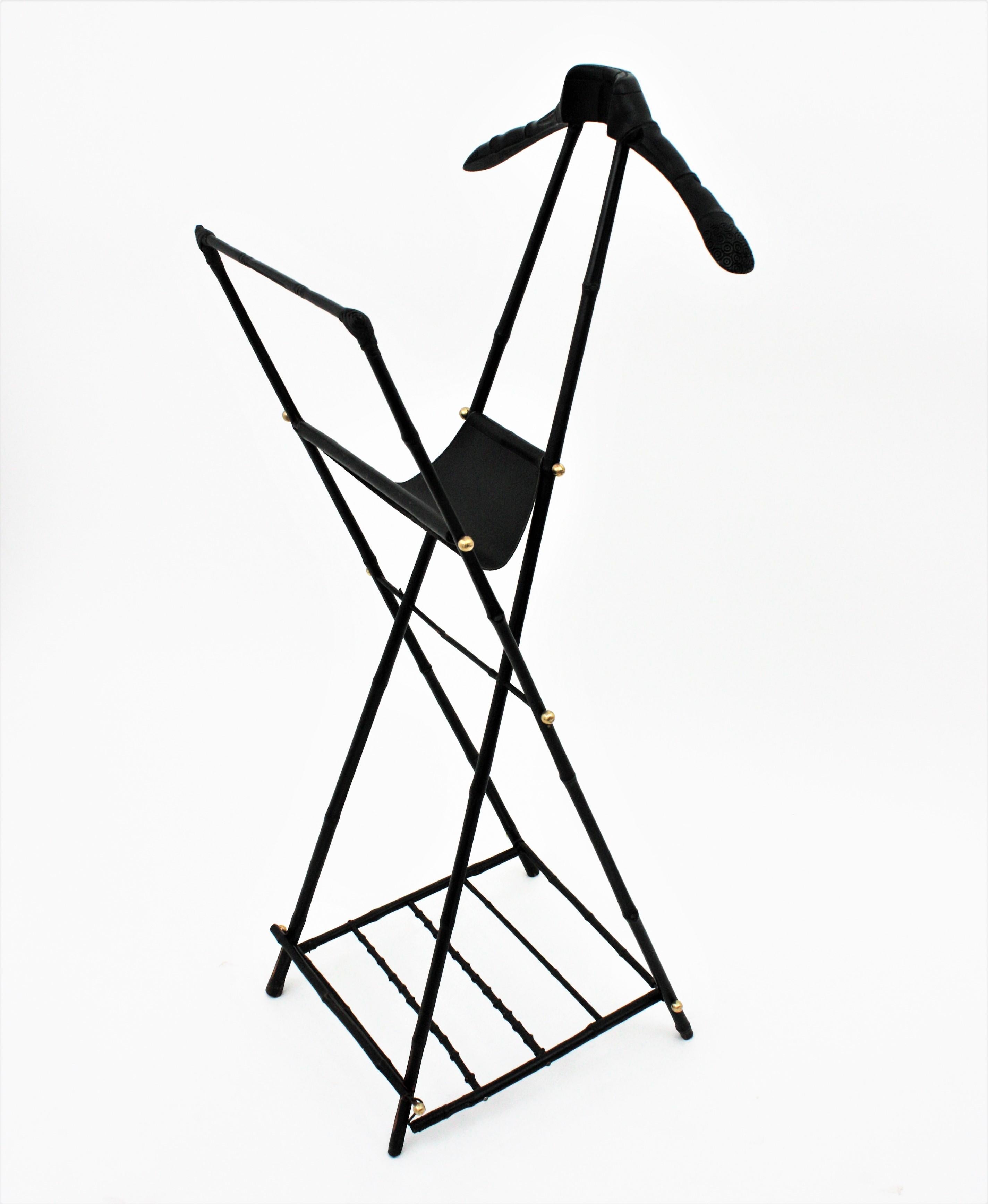 Jacques Adnet Foldable Valet or Coat Stand in Ebonized Bamboo & Black Leather, France, 1950s.
Gorgeous ebonized bamboo, wood and black leather folding valet with brass accents. Attributed to Jacques Adnet, 
This outstanding valet or coat stand is