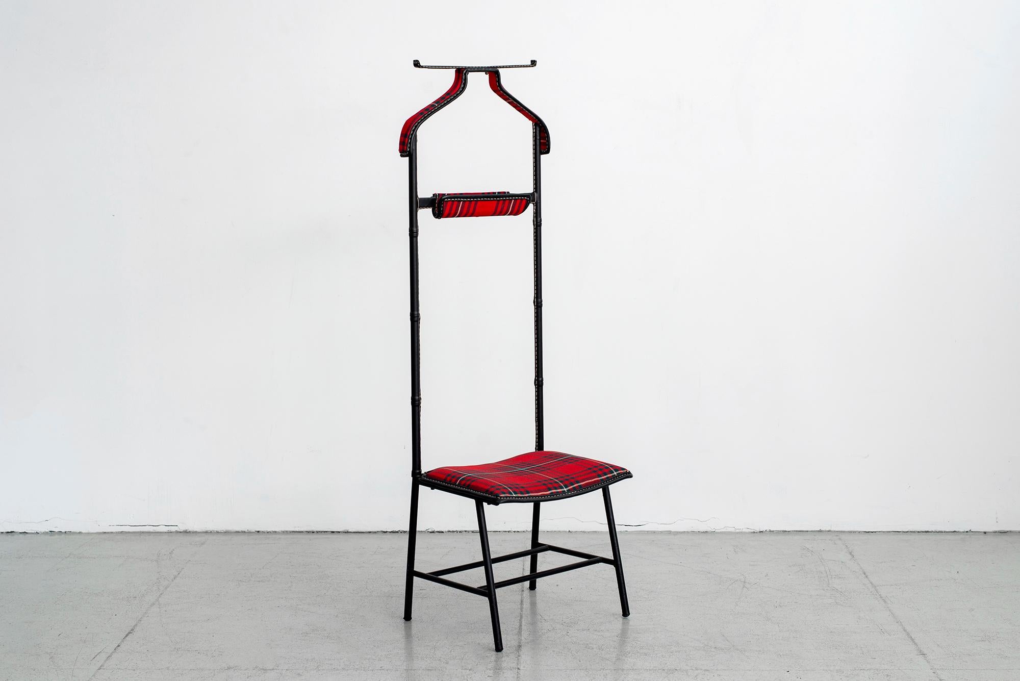 Jacques Adnet Valet in red tartan plaid seat, coat hanger and catch all. 
Signature black leather with contrast stitching. 

Measure: Seat height is 13
