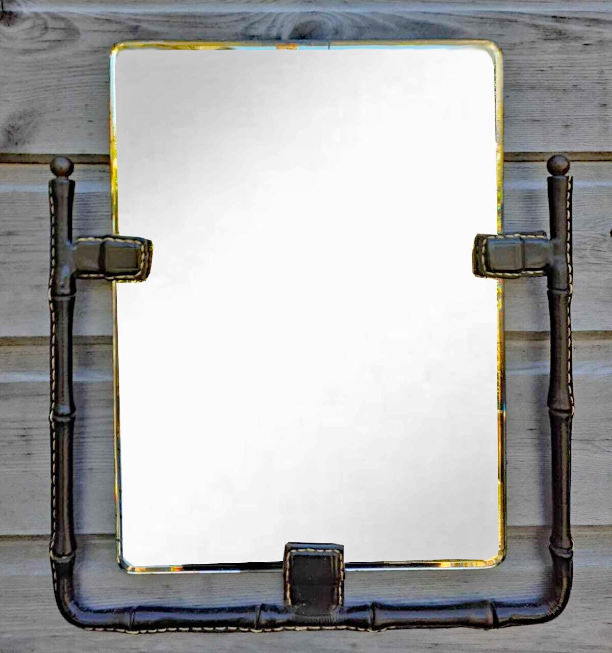 Français Miroir mural Jacques ADNET en cuir cousu à la selle, sphères en laiton, circa 1950 en vente
