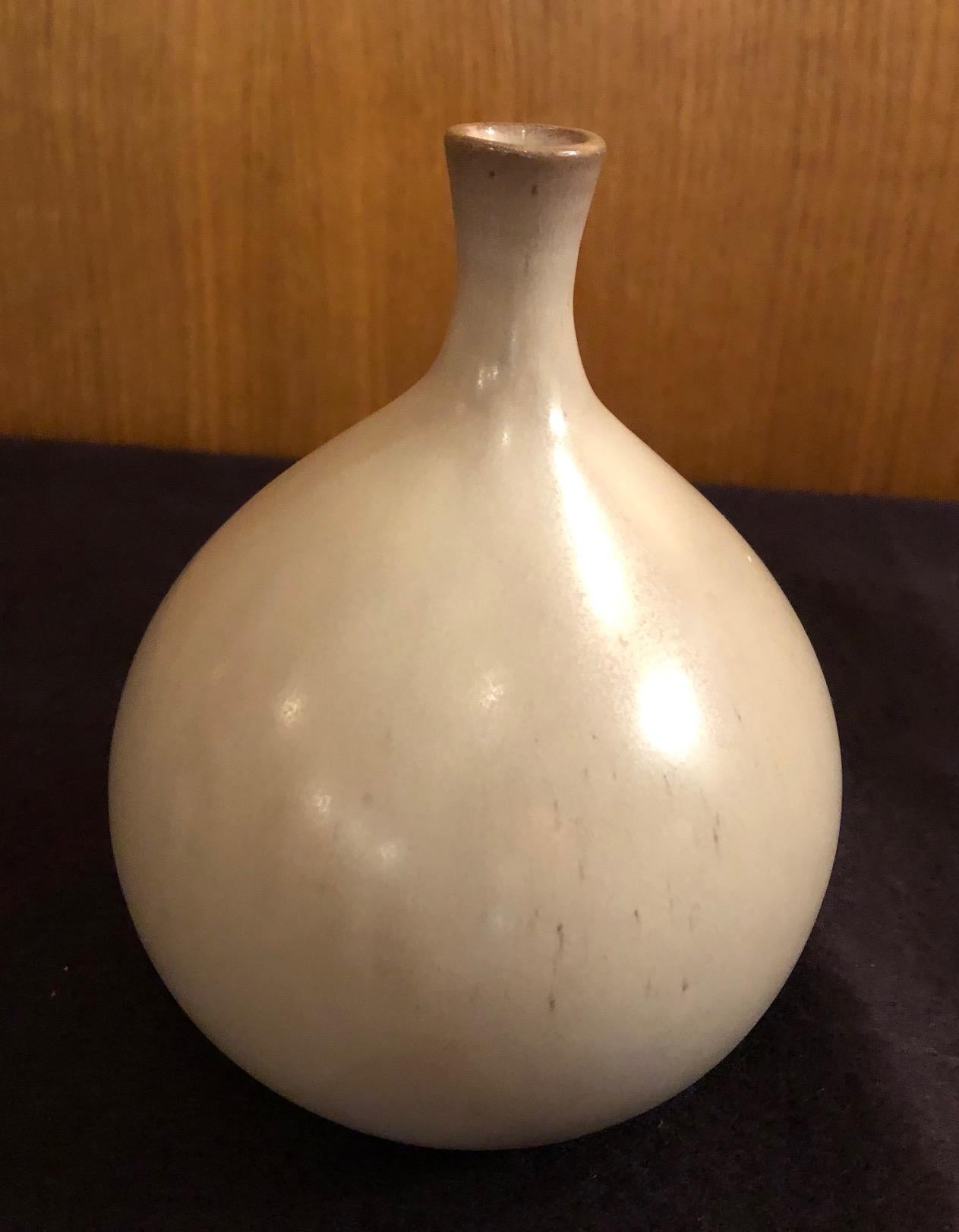A fig form vase by the French ceramic artists Jacques and Dani Ruelland. A pale grey glaze. Signed.