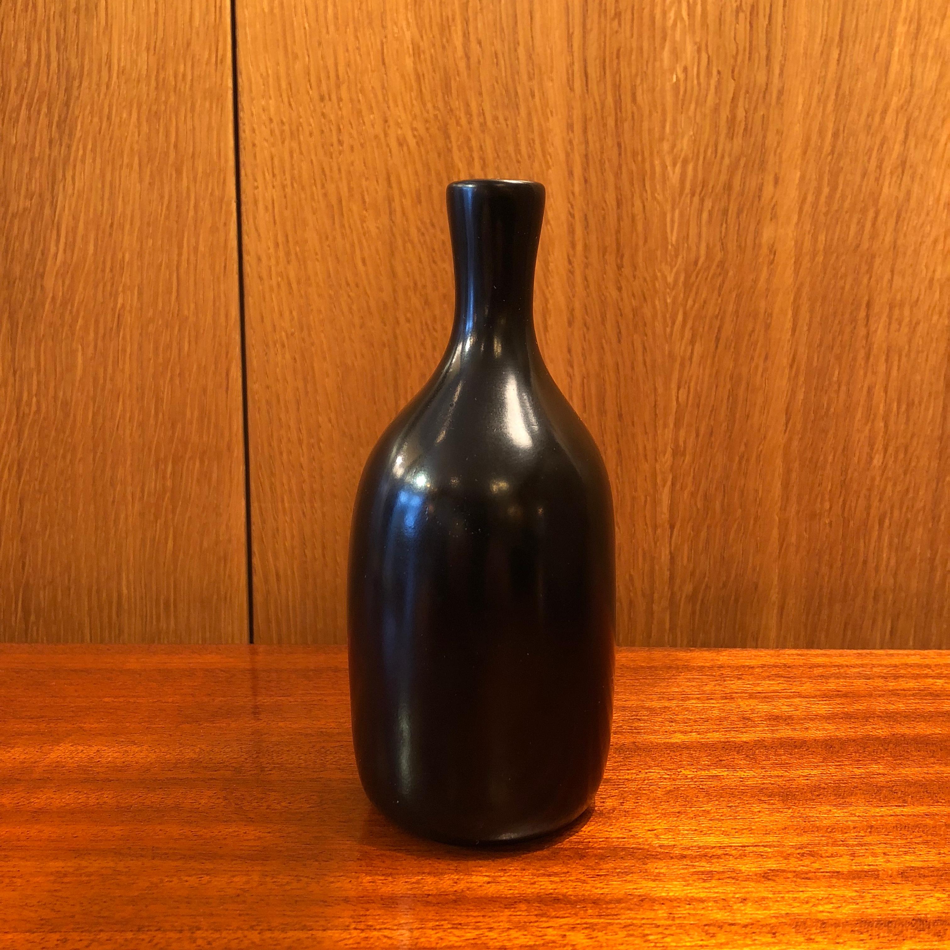 A small bottle form vase by the French ceramic artists Jacques and Dani Ruelland. A black glaze.