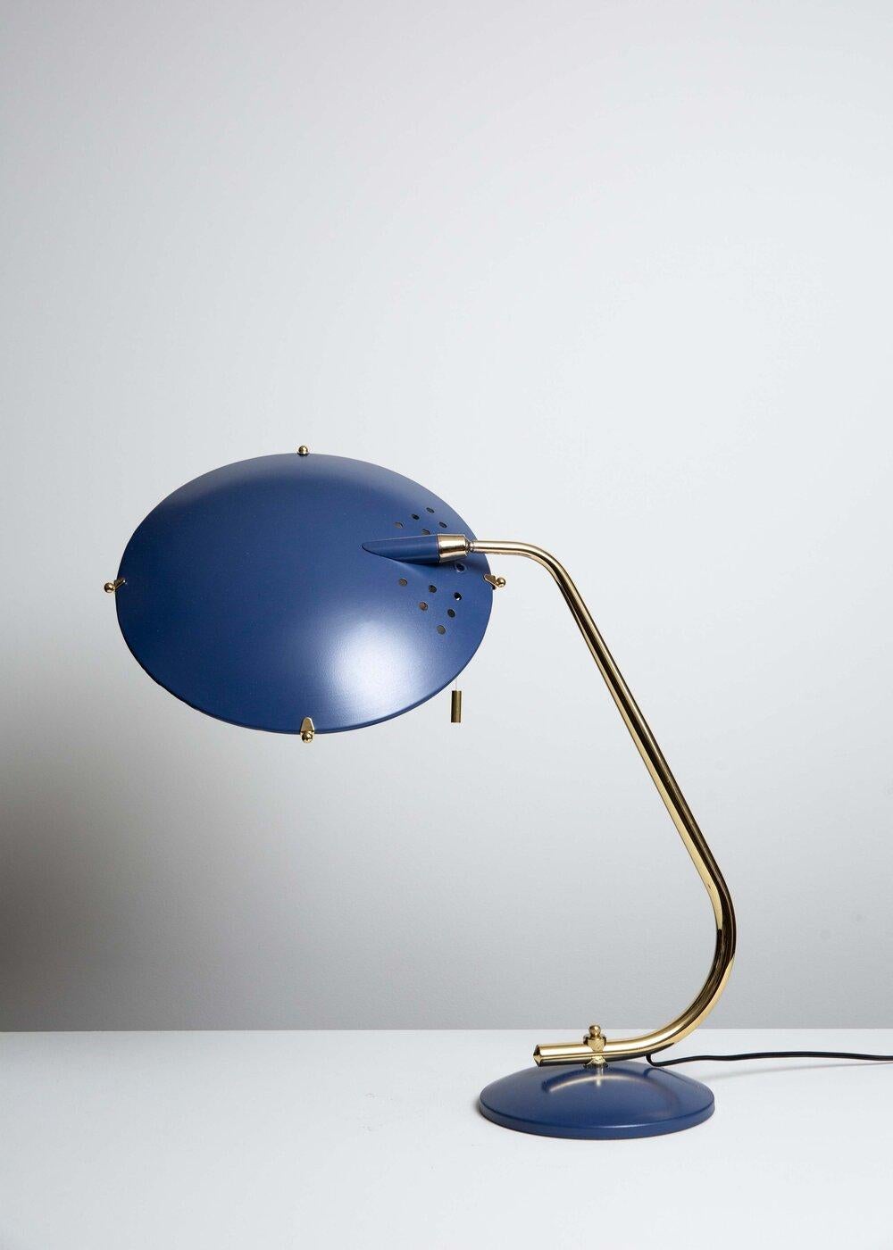 Jacques Biny attributed Jupiter desk lamp manufactured in the 1950s. Royal blue enamel on pierced aluminium saucer shade with brass clips, brass plated steel pivot, pull cord with brass trim, pivoting brass plated steel stem on royal blue steel