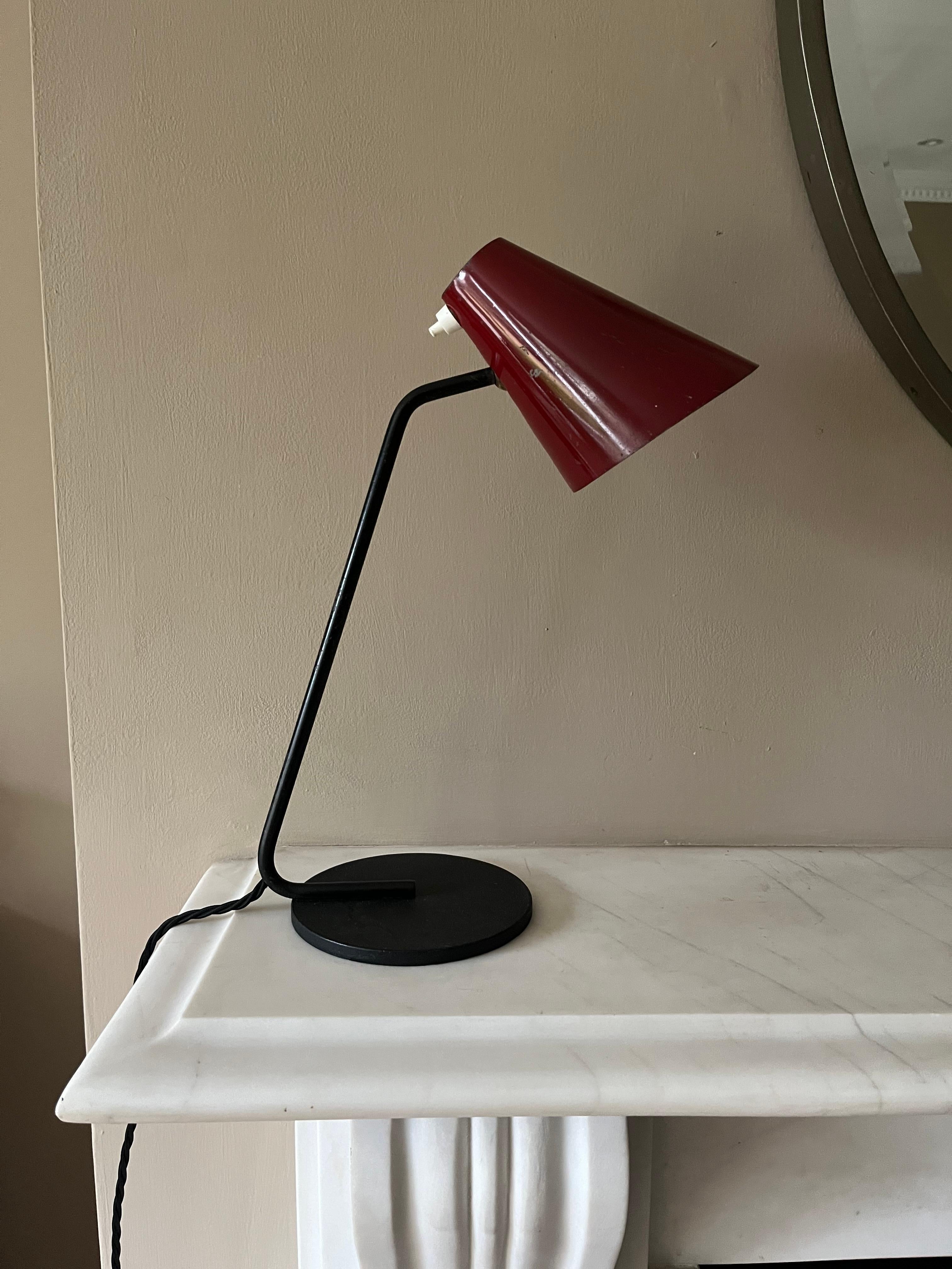 A French 1950’s small desk lamp by Jacques Biny. Original paint on shade some minor dents and paint loss.Rewired