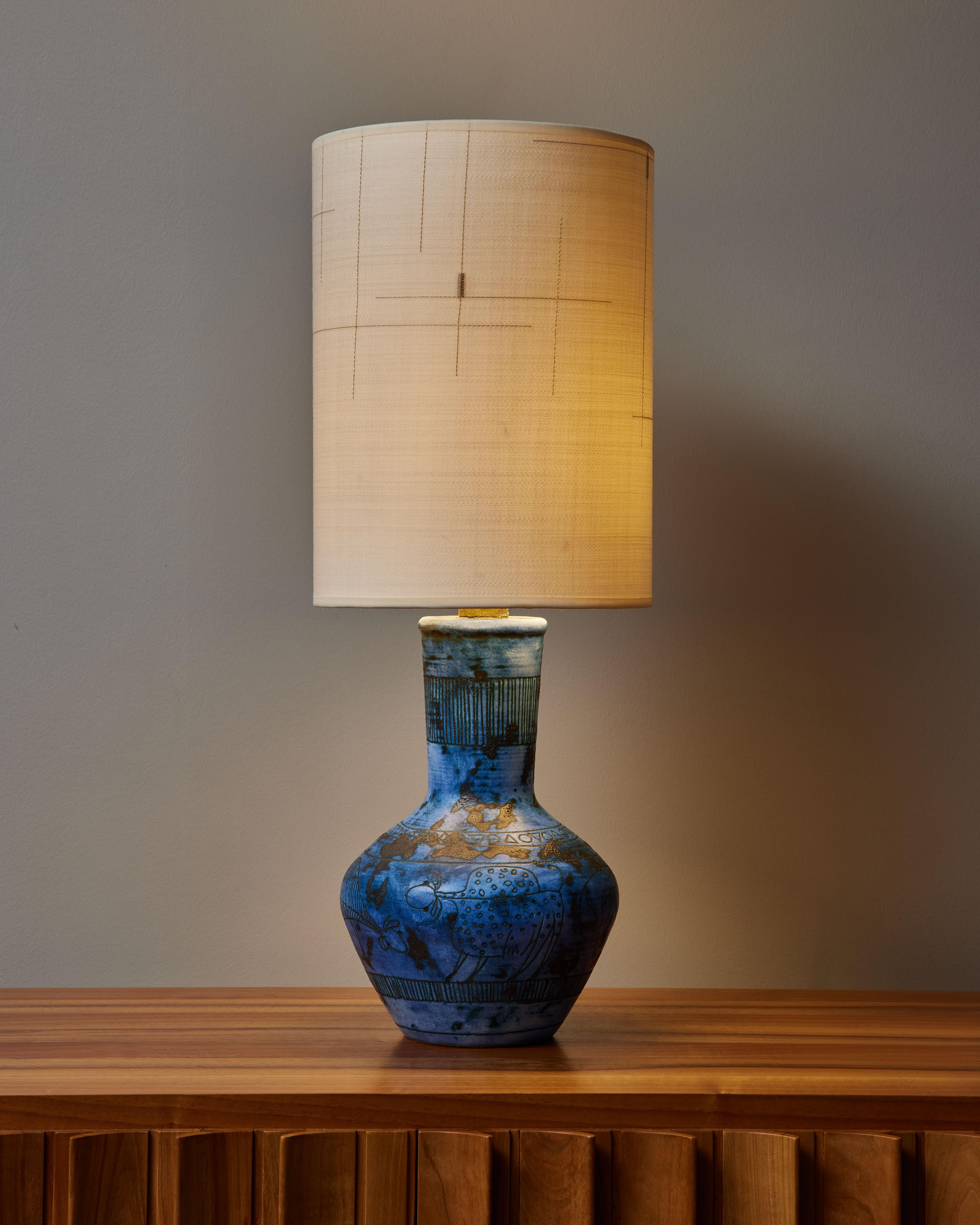 Blue ceramic table lamp by Jacques Blin, in a baluster shape, with engraved stylized animals and geometrical patterns. 
Signed at the bottom, new lampshade made with DEDAR fabric.

Jacques Blin (1920-1995) Jacques Blin is a well-known French