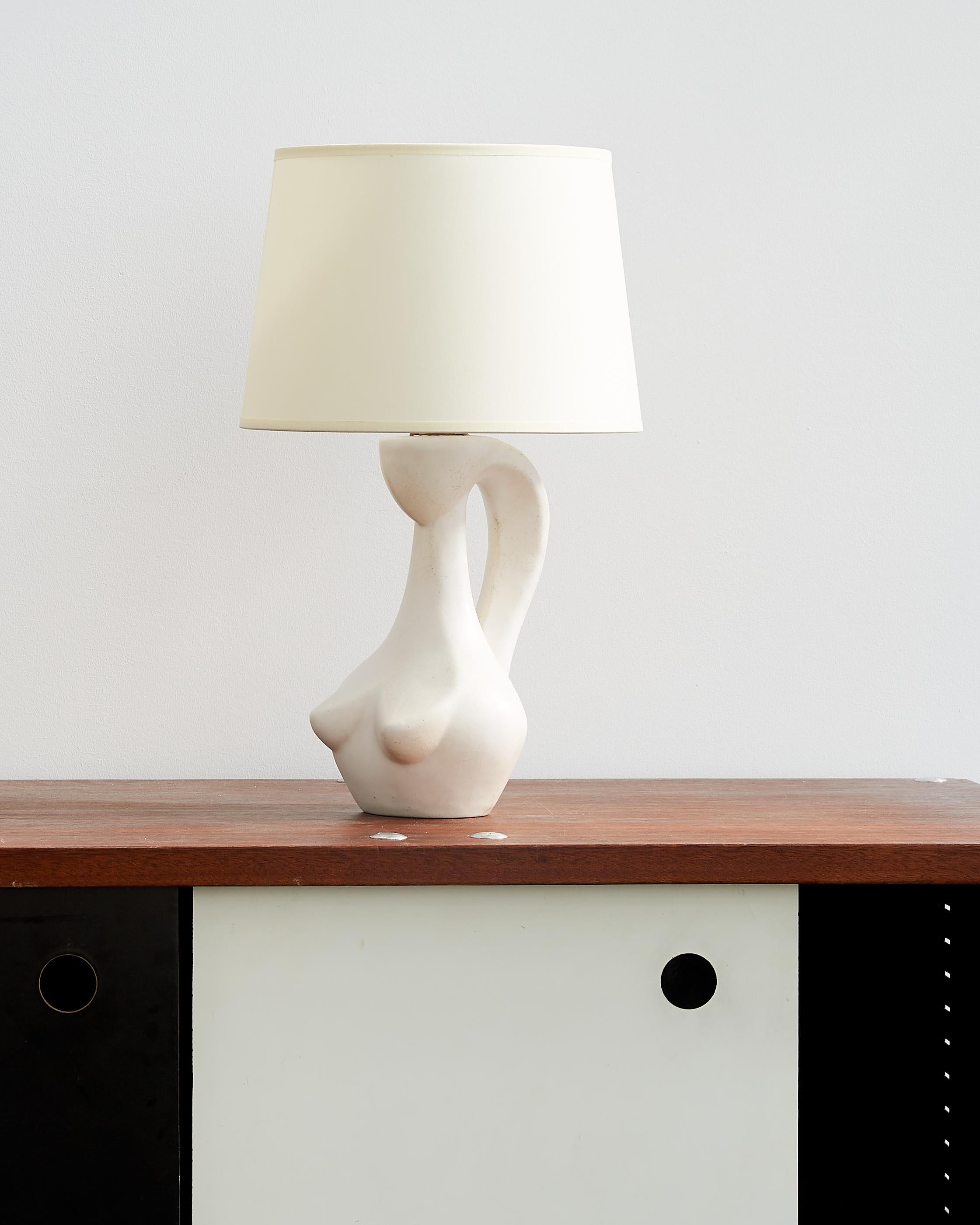 Jacques Blin ceramic table lamp in milk white glaze.

France. c. 1950.

Measurements: 15” height (with shade), 8.75” height (without shade), 9
