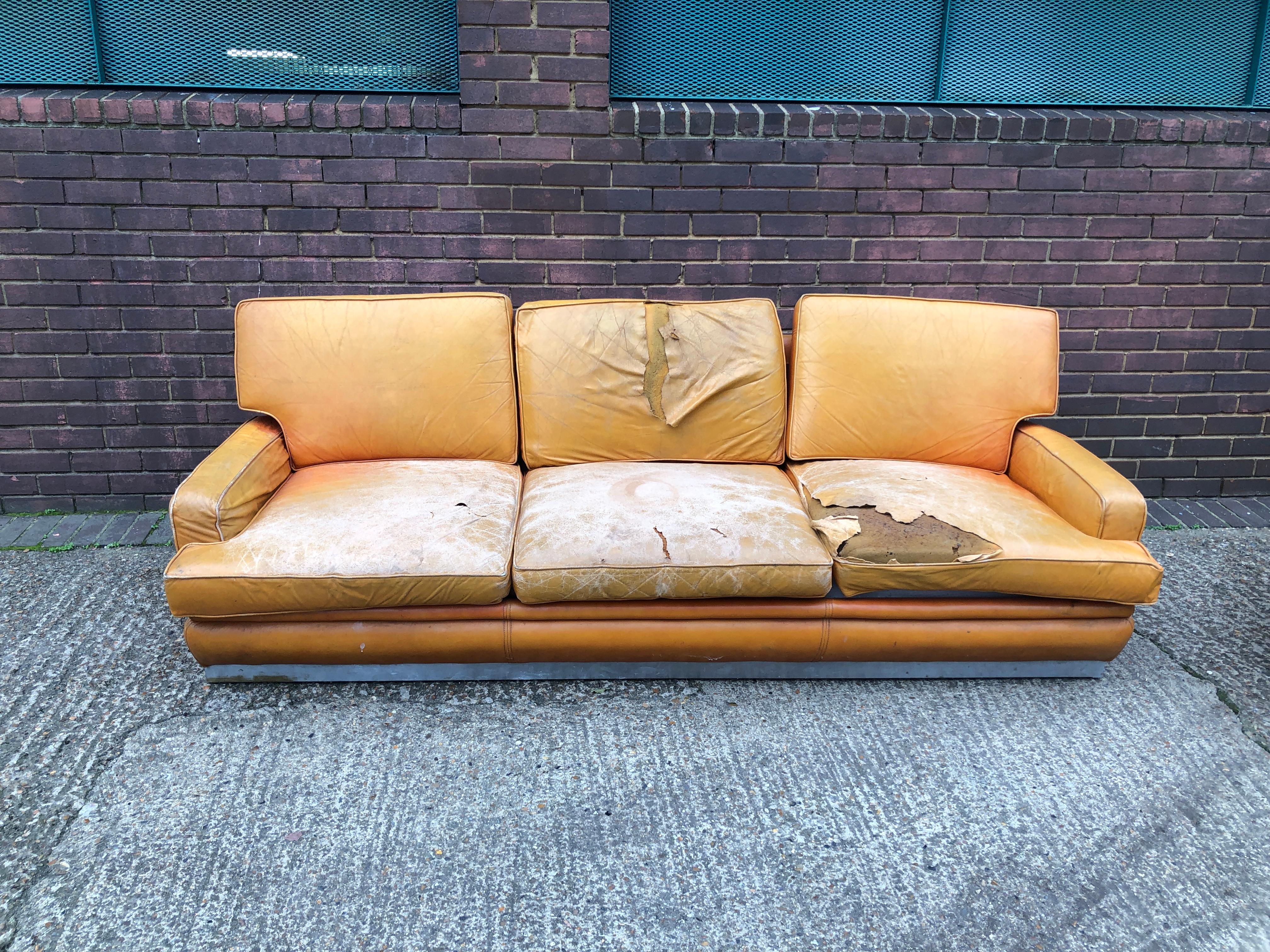 This stunning and amazingly comfortable leather and chrome three-seater sofa from Jacques Charpentier for Roche Bobois, is a beautiful example of 1970s French design. Currently upholstered in the original orange leather but the condition is worn and