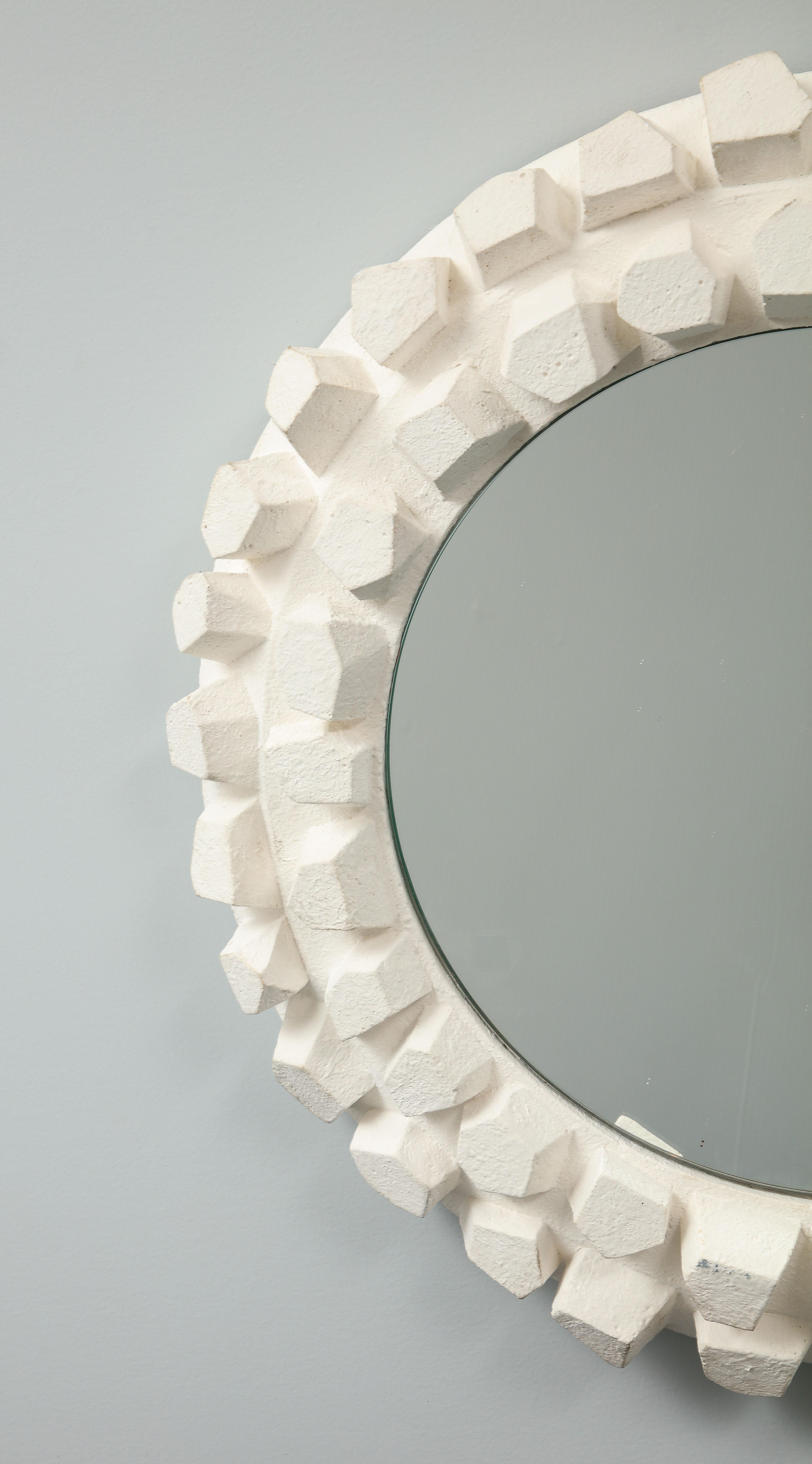 Jacques Darbaud designed this mirror in white plaster, inspired by brutalist esthetics. 