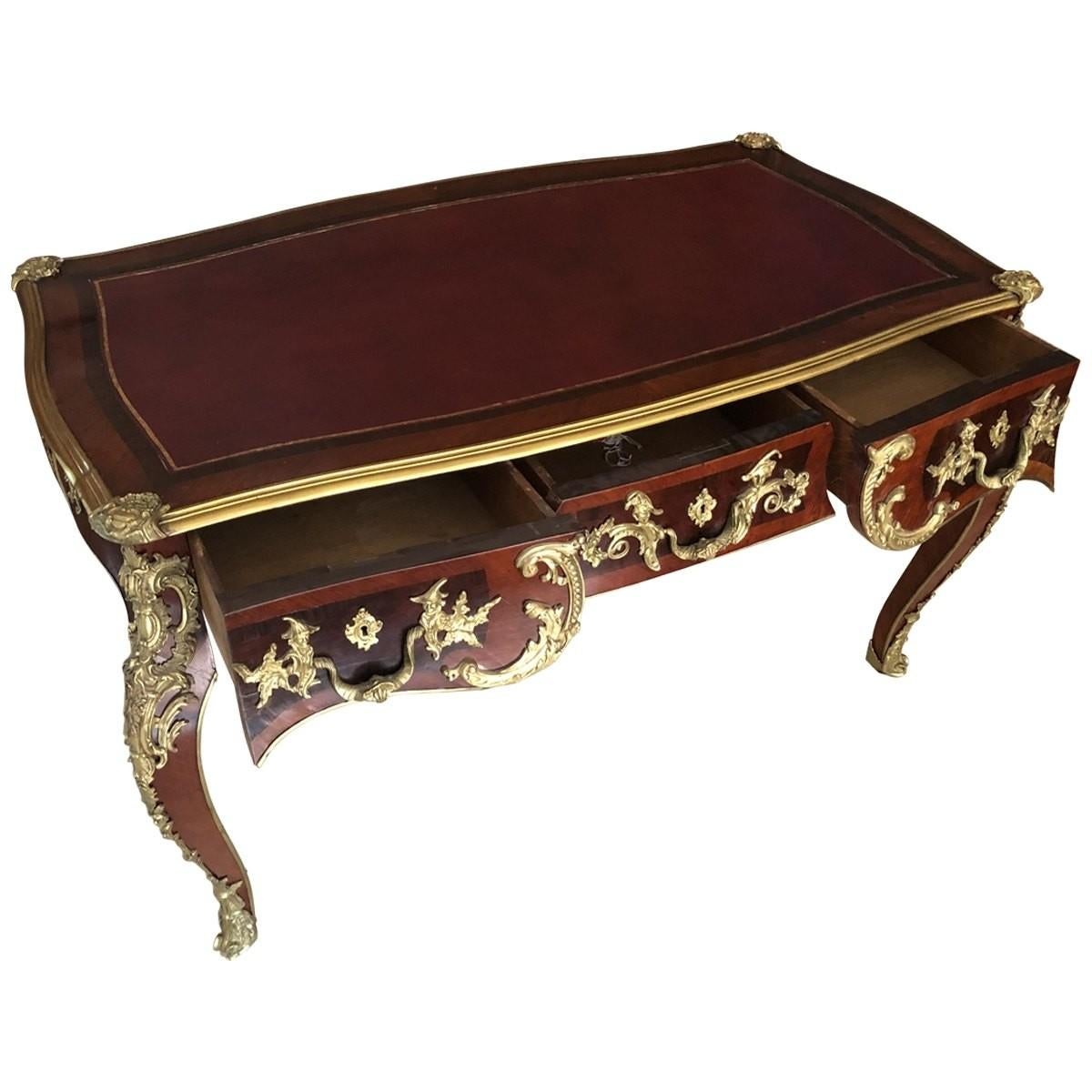 19th century opulent desk. Gilt bronze mounts and parquetry inlay decorate the desk to an air of old-world style. Features cabriole legs, three drawers, and a burgundy leather inset top.
Materials: Leather, bronze, Kingwood.
Dimensions:
Width