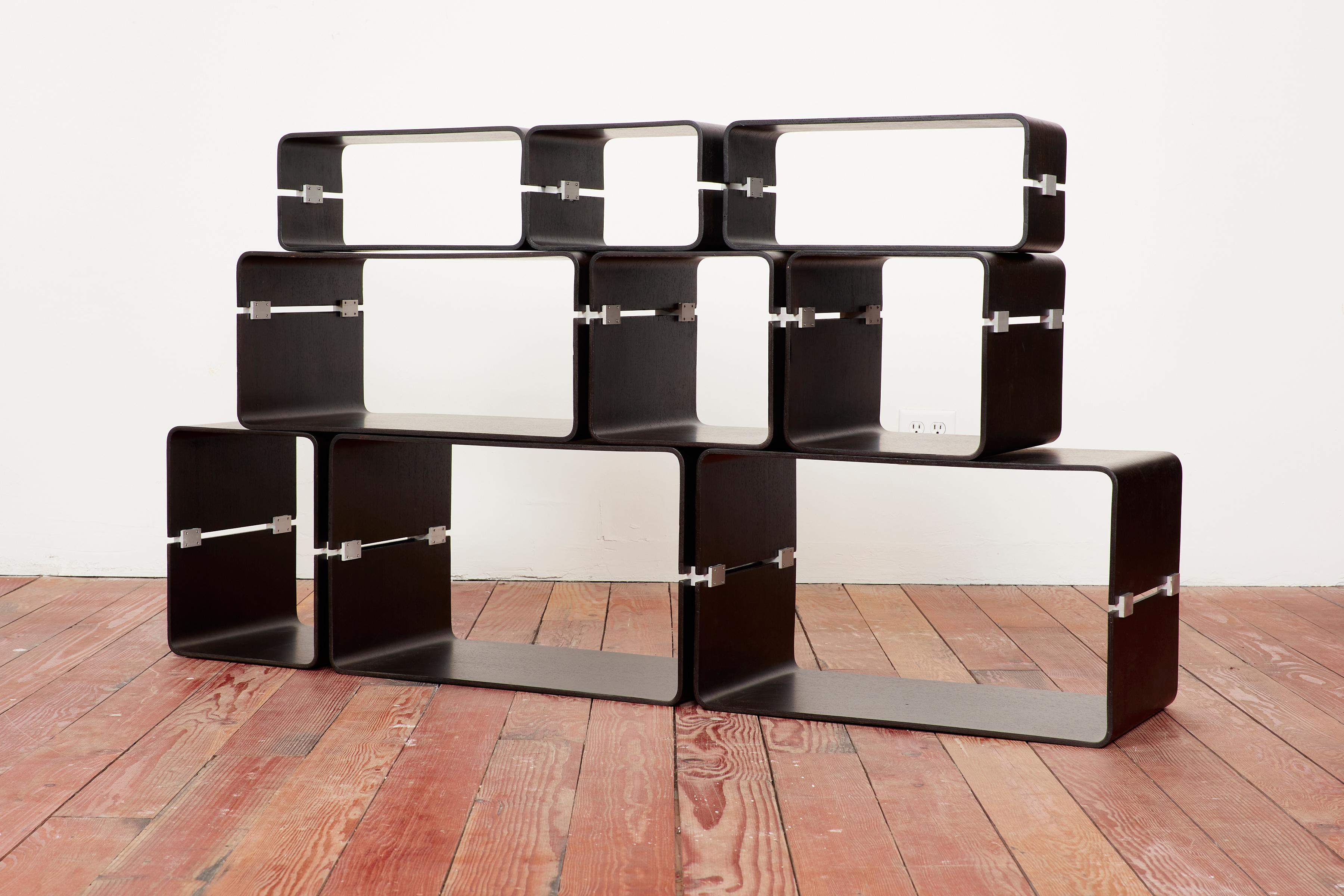 Jacques Dumond bookcase - Lyon, France circa 1963

Fully modular bookcase composed of nine boxes, each in two molded plywood elements connected by cast aluminum hardware that fasten them together.

Bookcase can be constructed in various