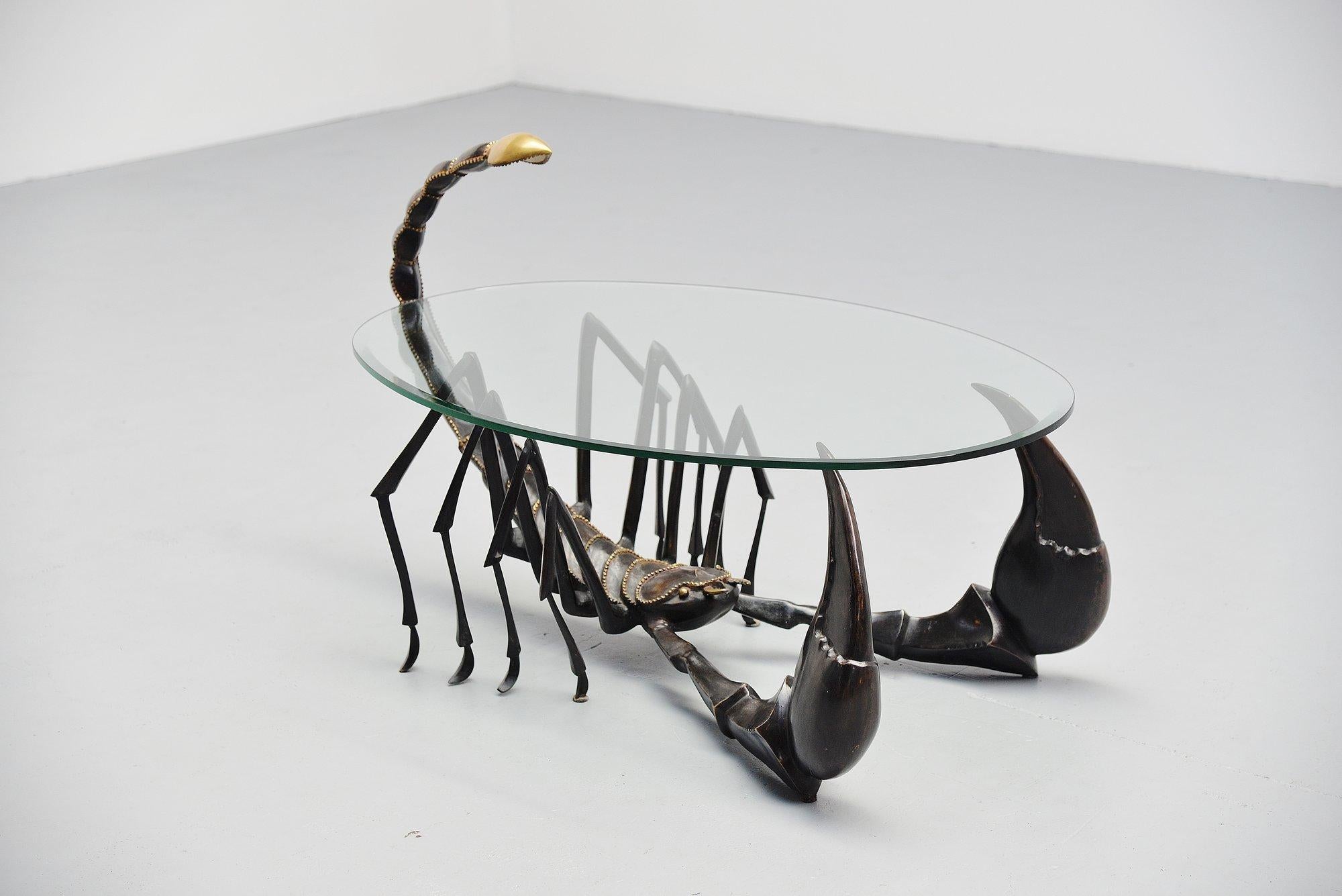 Very nice bronze crafted scorpion shaped coffee table attributed by Jacques Duval Brasseur, France 1970. This table in the shape of a scorpion was made of black patinated bronze and has bronze details. It is very heavy and has a thick oval hardend