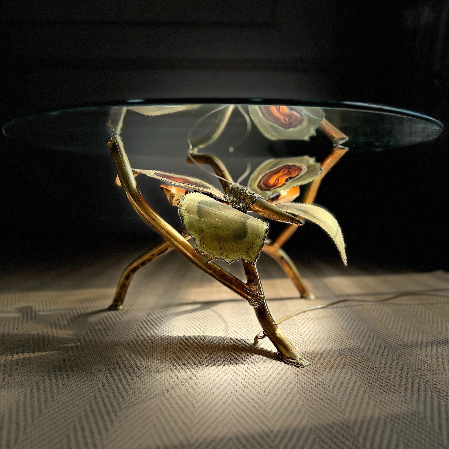 A beautiful butterfly inspired hand crafted coffee table, designed and made by the world renowned artist and sculptor Jacques Duval Brasseur in the 1970's. The stunning brass body is inset with two slices of Agate stone, one on each wing, these are