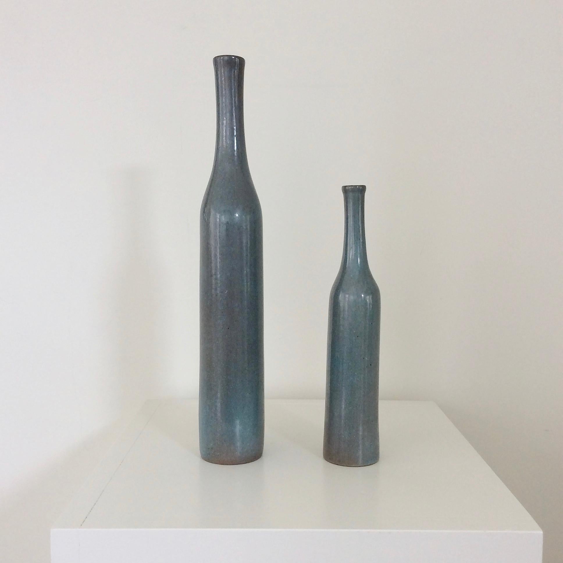 Pair of iconic bottles form by the French ceramic artists Jacques and Dani Ruelland, circa 1960, France.
Delicate shades of grey or pale blue glazed ceramic.
Both signed 