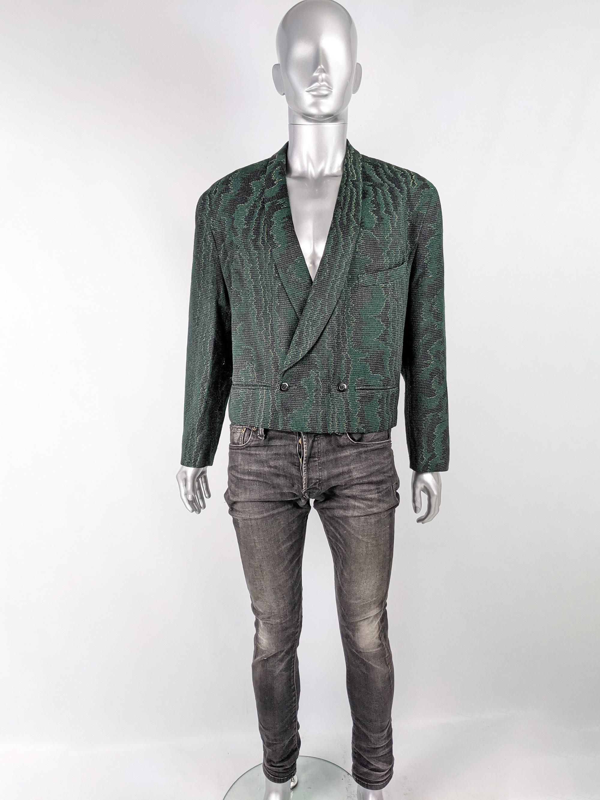 A super cool vintage mens jacket from the 80s by luxury French fashion house, Jacques Fath (a rare example of their menswear). In a charcoal grey and green abstract patterned metallic brocade fabric with shawl lapels and a short, military inspired