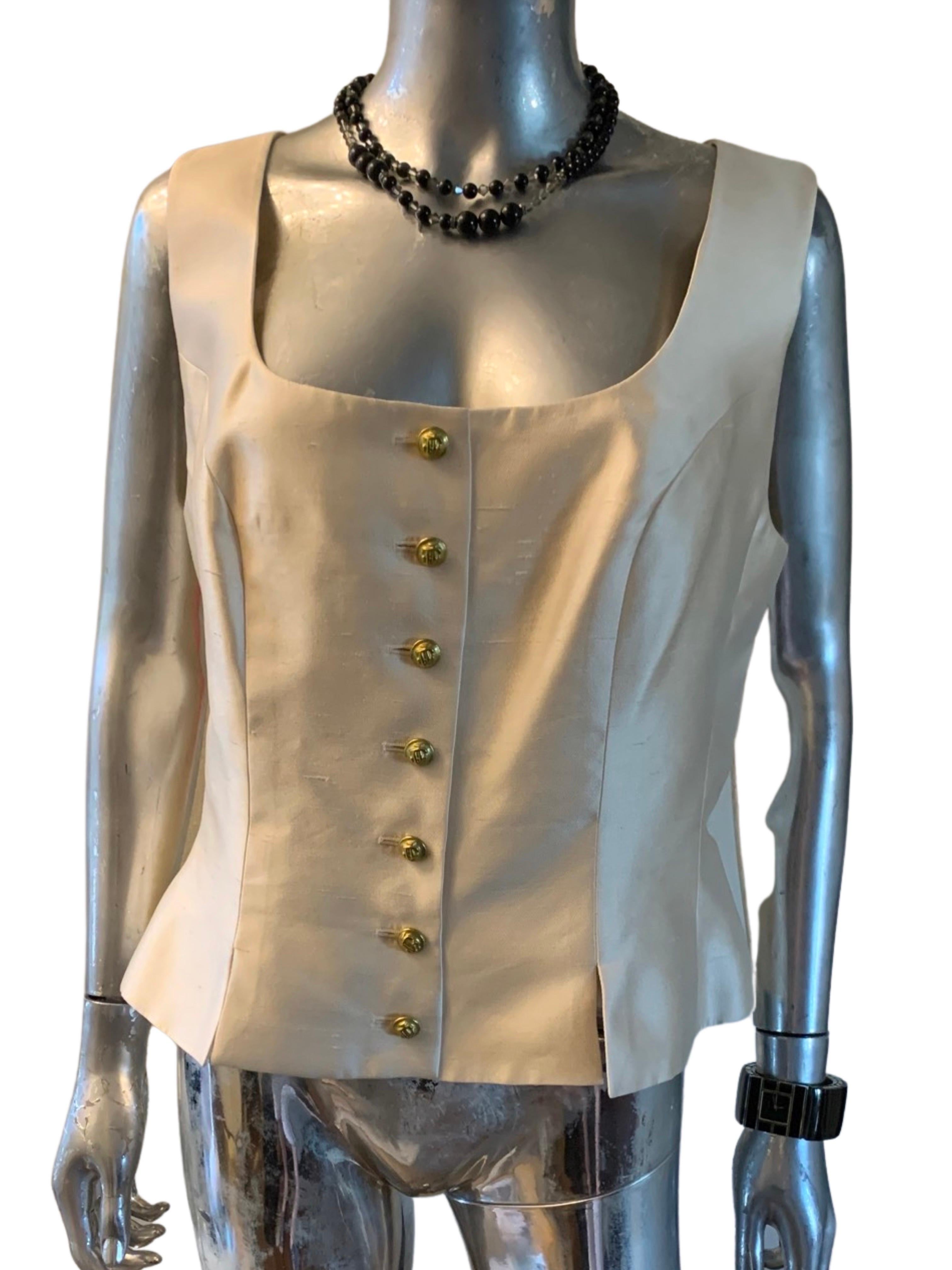 Rarely do you find a vintage piece from a designer house like Jacques Fath Paris that is Plus Size 18 and purchased in Paris and never worn. A creme silk sleeveless blouse (or vest) that is beautifully shaped with a soft pleated peplum at the waist.
