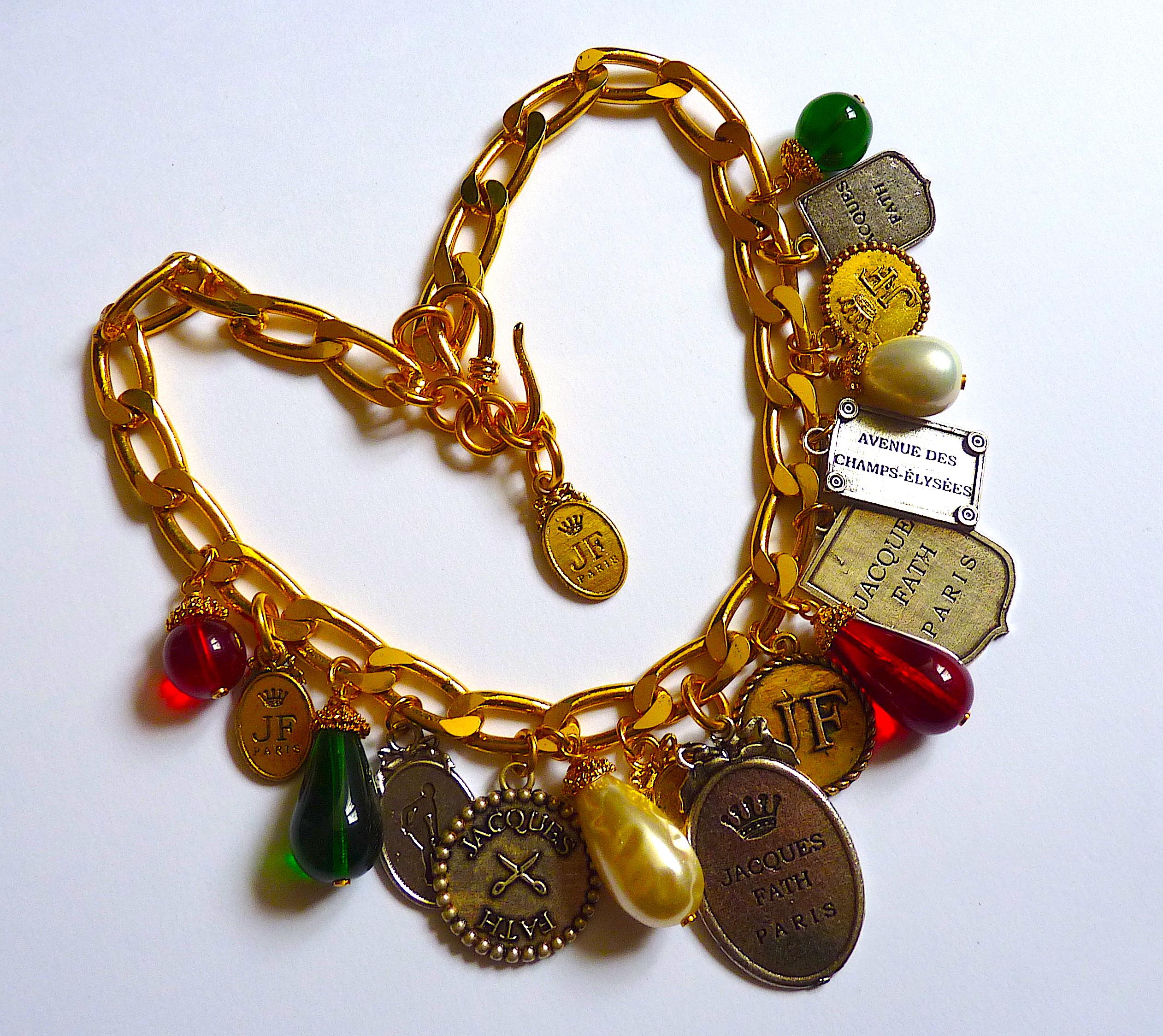 Jacques Fath Paris poured glass and charms choker Necklace, gold tone Metal and Red, Green, Poured Glass Drops, Ultra Rare Masterpiece and Highly Collectable ! Rare Vintage from the 1980s

Stamped Jacque Fath Paris on the charms and metal tag with