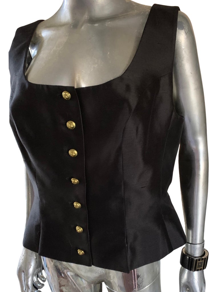 Rarely do you find a vintage piece from a designer house like Jacques Fath Paris that is Plus Size 18 and purchased in Paris and never worn. A black silk sleeveless blouse (or vest) that is beautifully shaped with a soft pleated peplum at the waist.