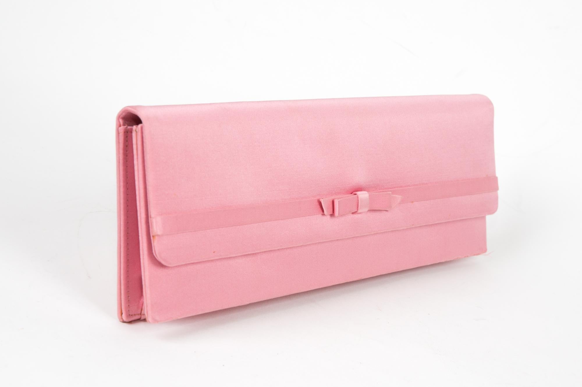 Jacques Fath pink silk clutch bag featuring a long shape, two snaps opening, inside small pocket.
Length 13.7in. (35cm)
Height: 3.5in. (9cm)
Width:1.18in. (3cm) 
In good vintage condition.  Made in France.
Please note this item is in good condition