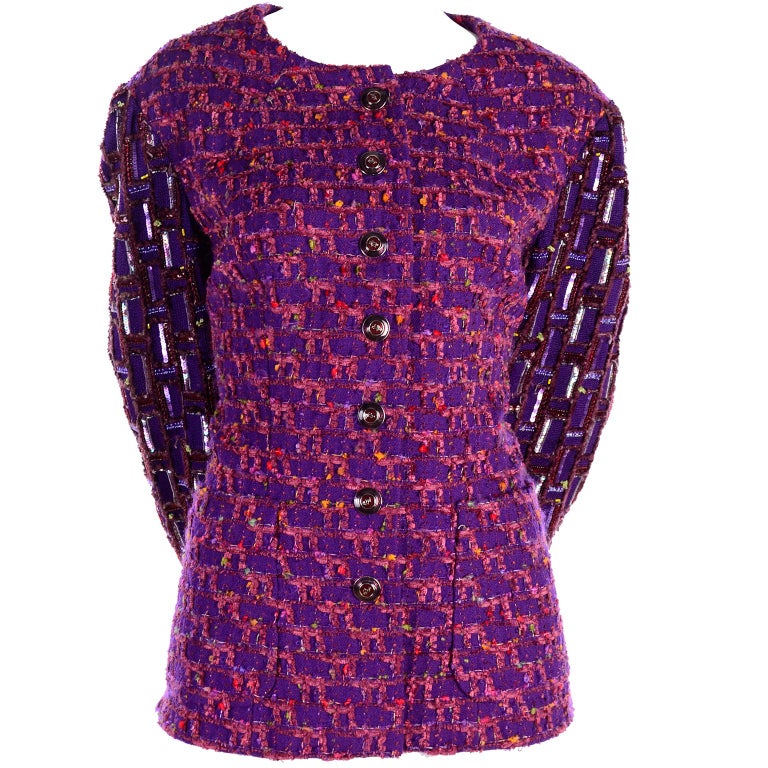 This is a beautiful vintage Jacques Fath purple tweed jacket with hints of orange, yellow, red and green.  The fully lined blazer has shoulder pads, pockets, buttons up the front and the sleeves have sequins and beading.  This jacket was purchased