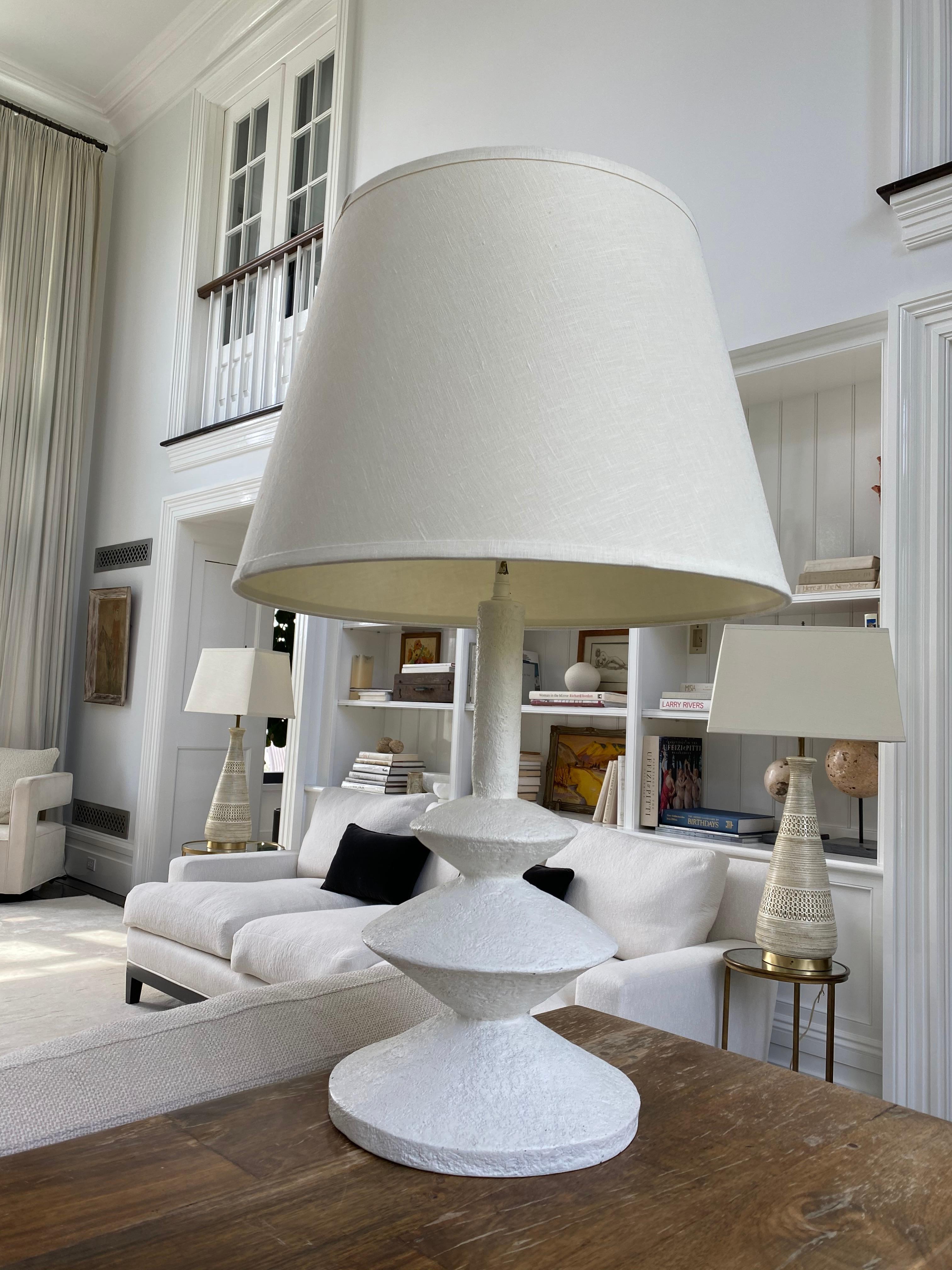 Plaster triple disc lamp with linen shade.

30 x 10 inches, without shade. Shade can be included upon request and additional shipping.

Yves Saint Laurent, fashion designer and substantial art & antiquities collector, was enamored by a lamp he