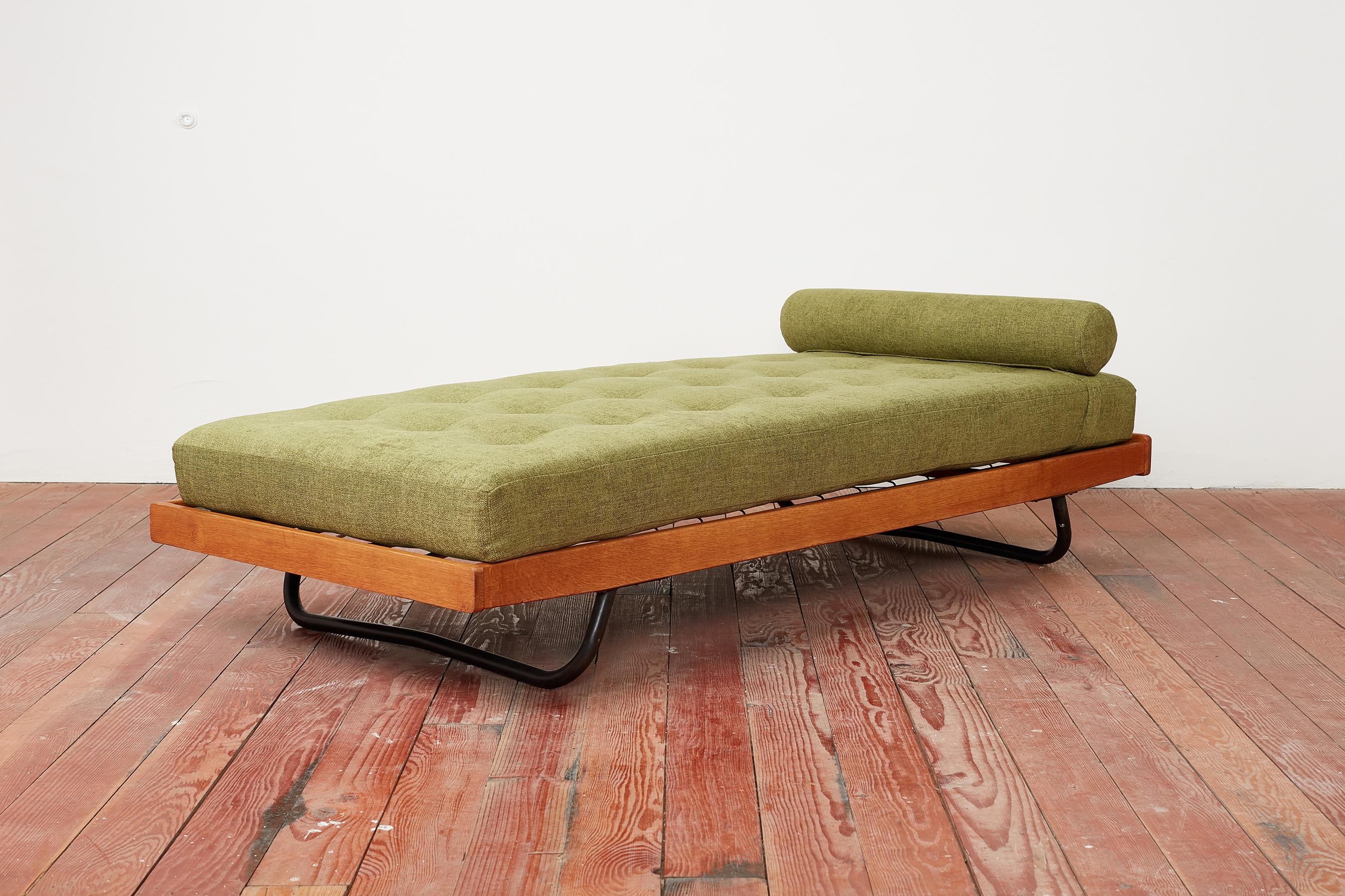 Jacques Hitier attributed daybed with wonderfully patina'd oak frame floating on 2 tubular black iron legs.
Newly reupholstered in thick green linen with bolster.