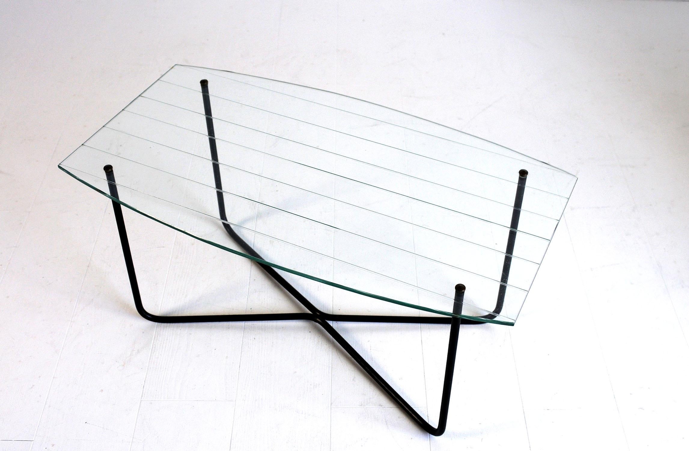 Jacques Hitier, Minimalist coffee table number 36 in black lacquered tubular metal and glass, France 1955. The X-shaped base is assembled in the center, four blind screws in patinated brass secure the top. The grooved transparent glass slab is in