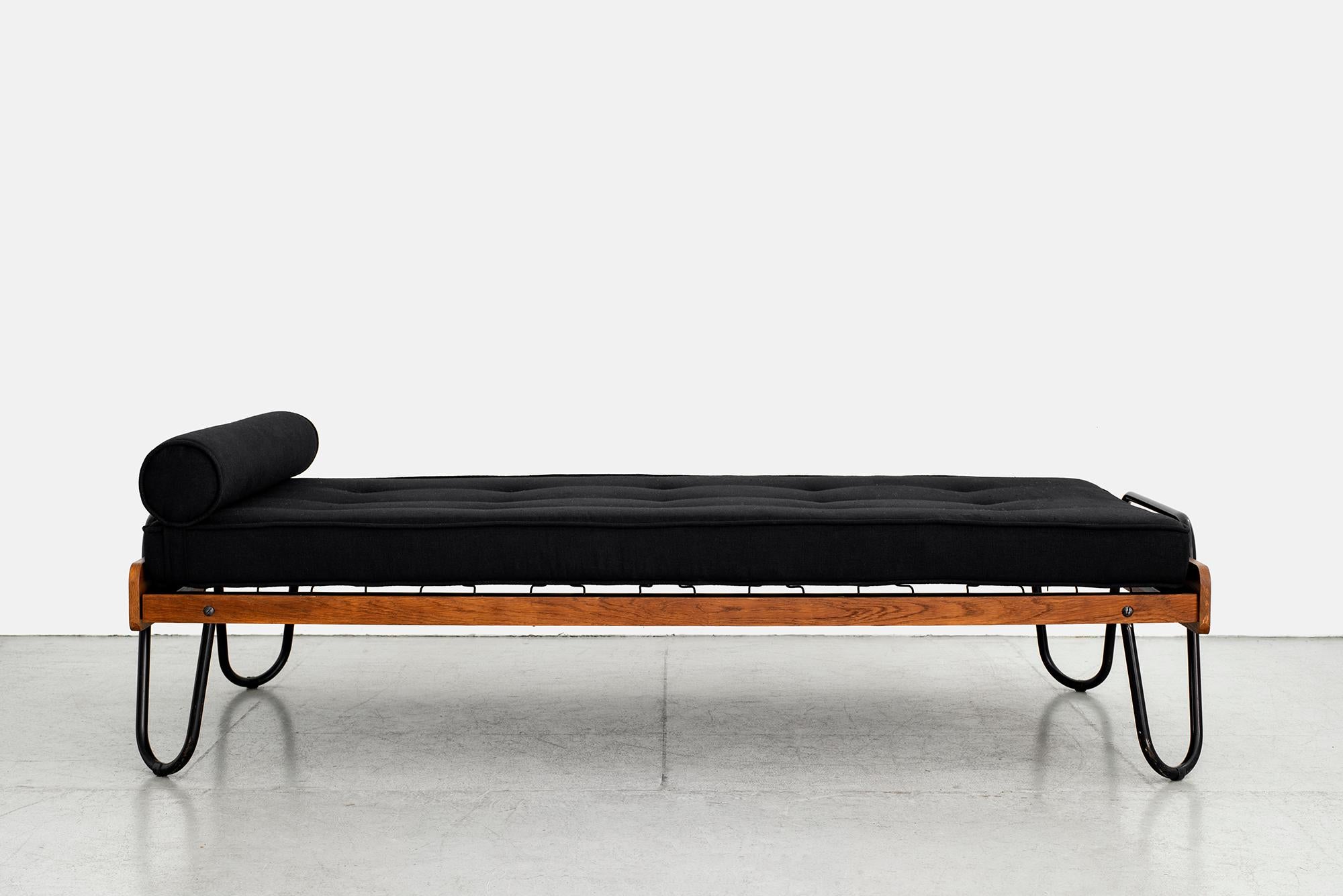French daybed by Jacques Hitier with wood frame and signature bent tubular iron frame
Upholstery is original black linen and has a large stitched repair (see photo)
Can be reupholstered in COM for additional charge.