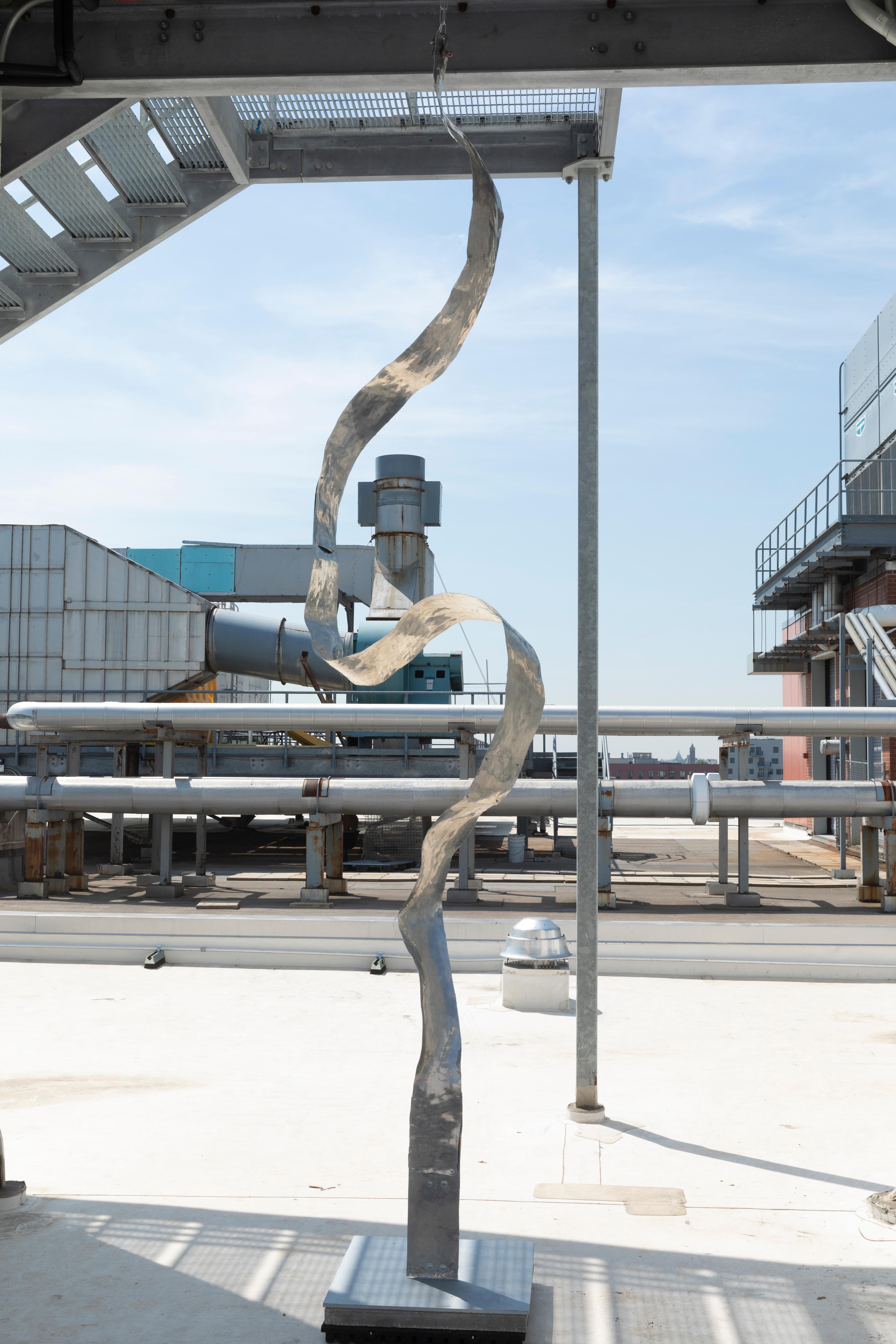 Measuring 144 inches in height, this monumental suspended sculpture by Jacques Jarrige is shaped entirely from hand-hammered aluminum and conceived as a vertical gesture—at once responsive to gravity and released into motion. Jarrige envisioned a