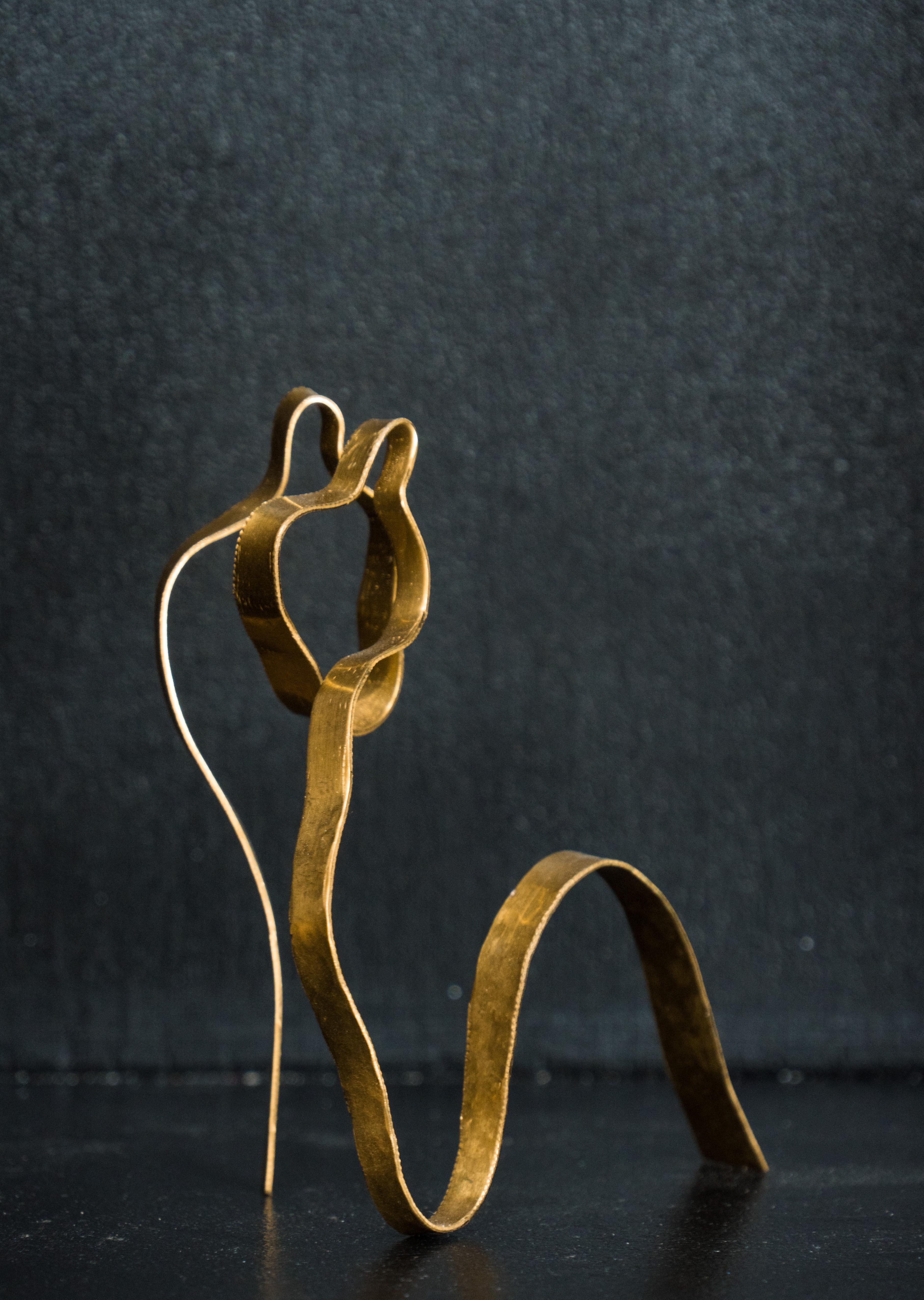 Sculpture formed from a strip of brass and hand hammered. Figurative Minimalist Figures embraced.  Unique and signed
