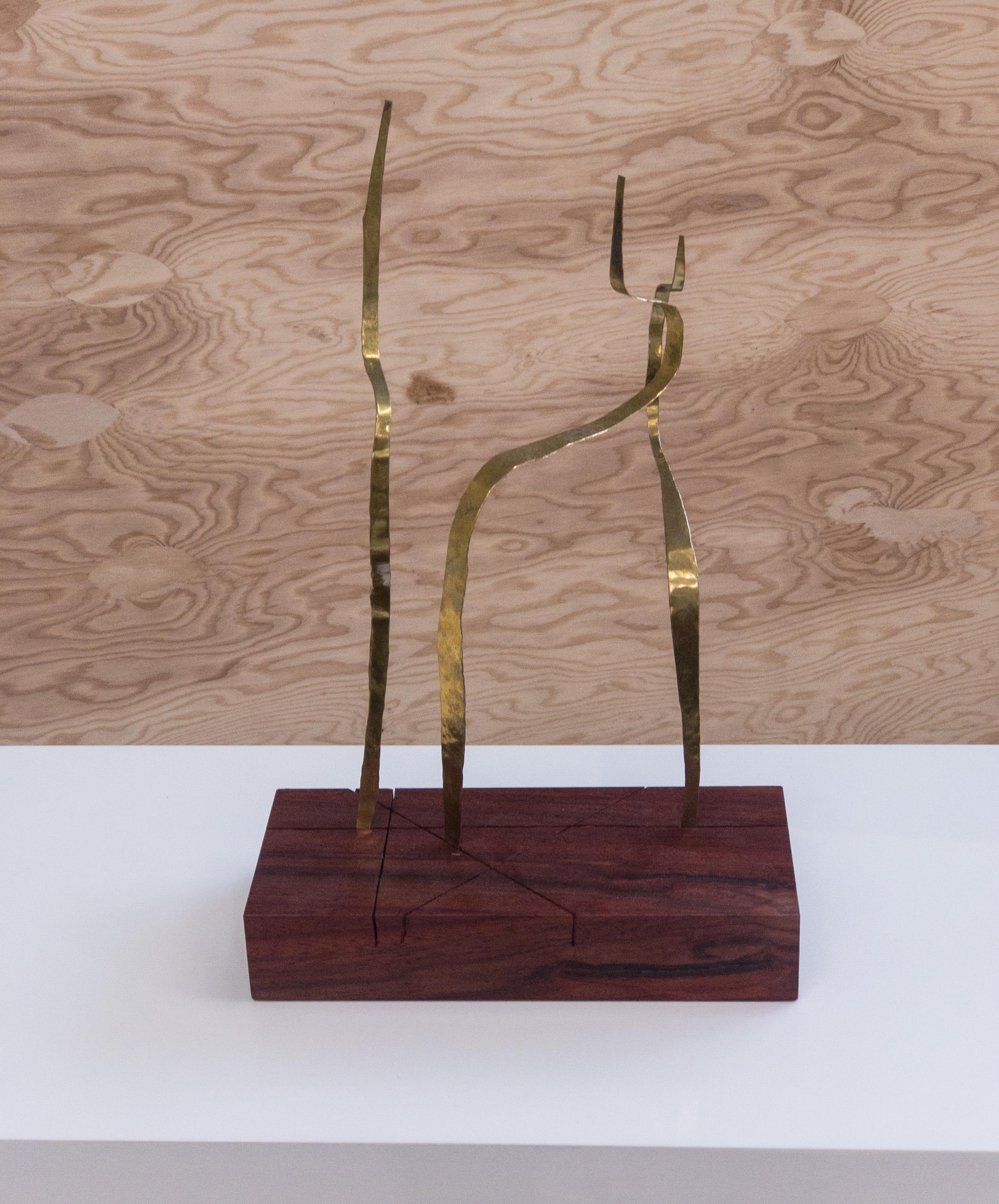 Minimalist sculpture formed by 3 bands of brass cut and hammered  then arranged on a base of mahogany wood. From every angles the sculpture offers another image renewing  the pleasure of discovery. Unique and signed
