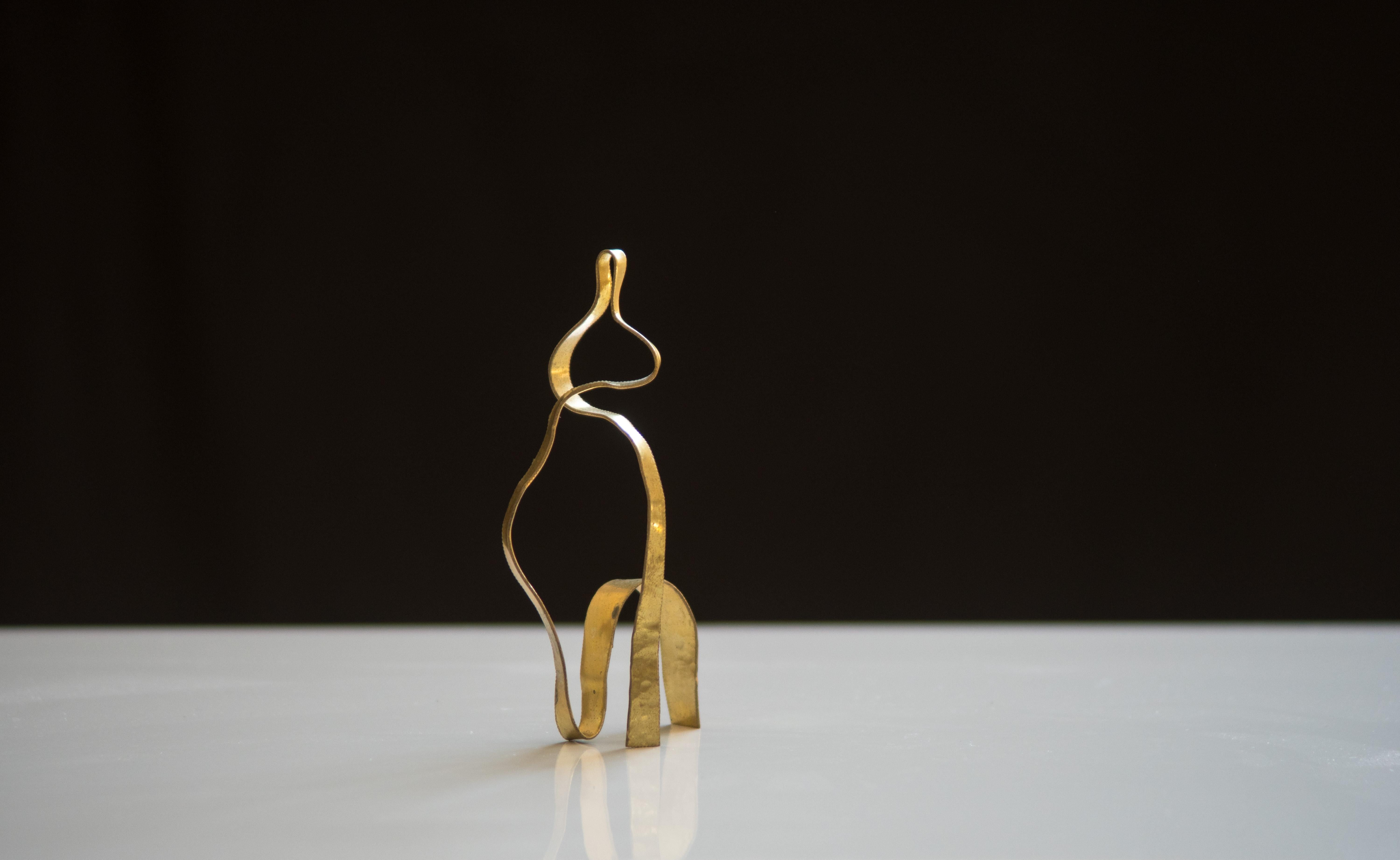 A minimalist yet complex small scale sculpture formed by a band of brass and hammered. Unique piece